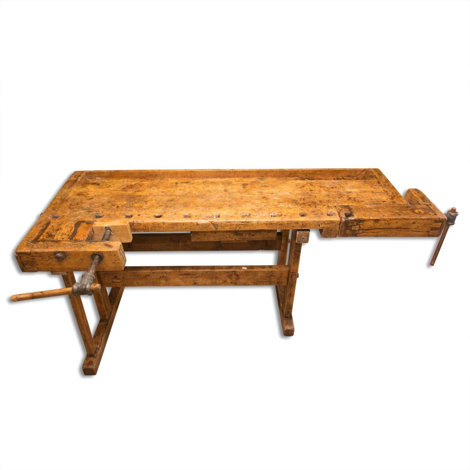 Antique European carpenters' workbench with very nice patina, made in the 1920s in Central Europe. It´s made of oakwood. It features one drawer, two wooden vices with wood handle. It has been restored and waxed using a beeswax. These workbenches are