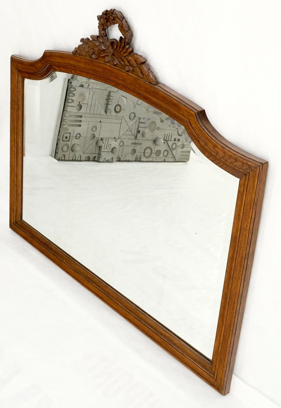 Antique oak carved figural beveled glass horizontal wall mirror.