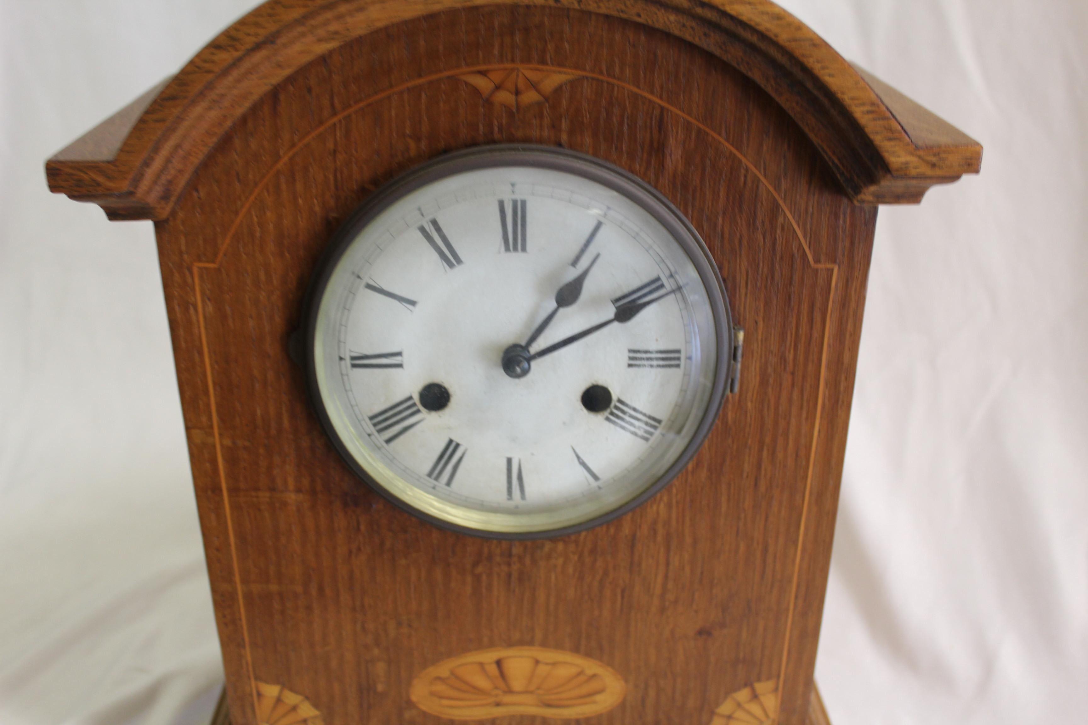 A well made Clock with Wooden case and Inlaid shell design. Has an 8 day movement and chimes. Dial is enameled and Brass ring. Pendulum is inside. No maker marks found. Did not take movement out of the case. Purchased in England 40 years ago. Keep