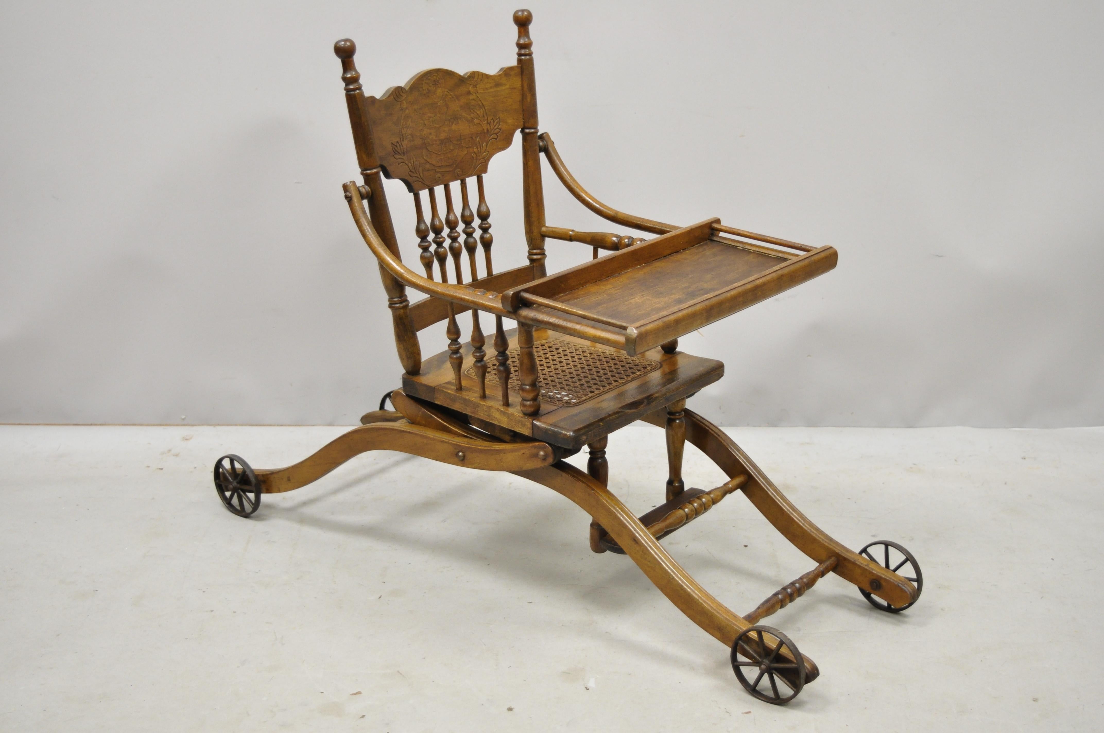Antique oak convertible pressed back Victorian high chair baby stroller. Item features convertible frame, cast iron wheels, beautiful wood grain, very nice antique item, circa 1900. Measurements: Up: 40.5