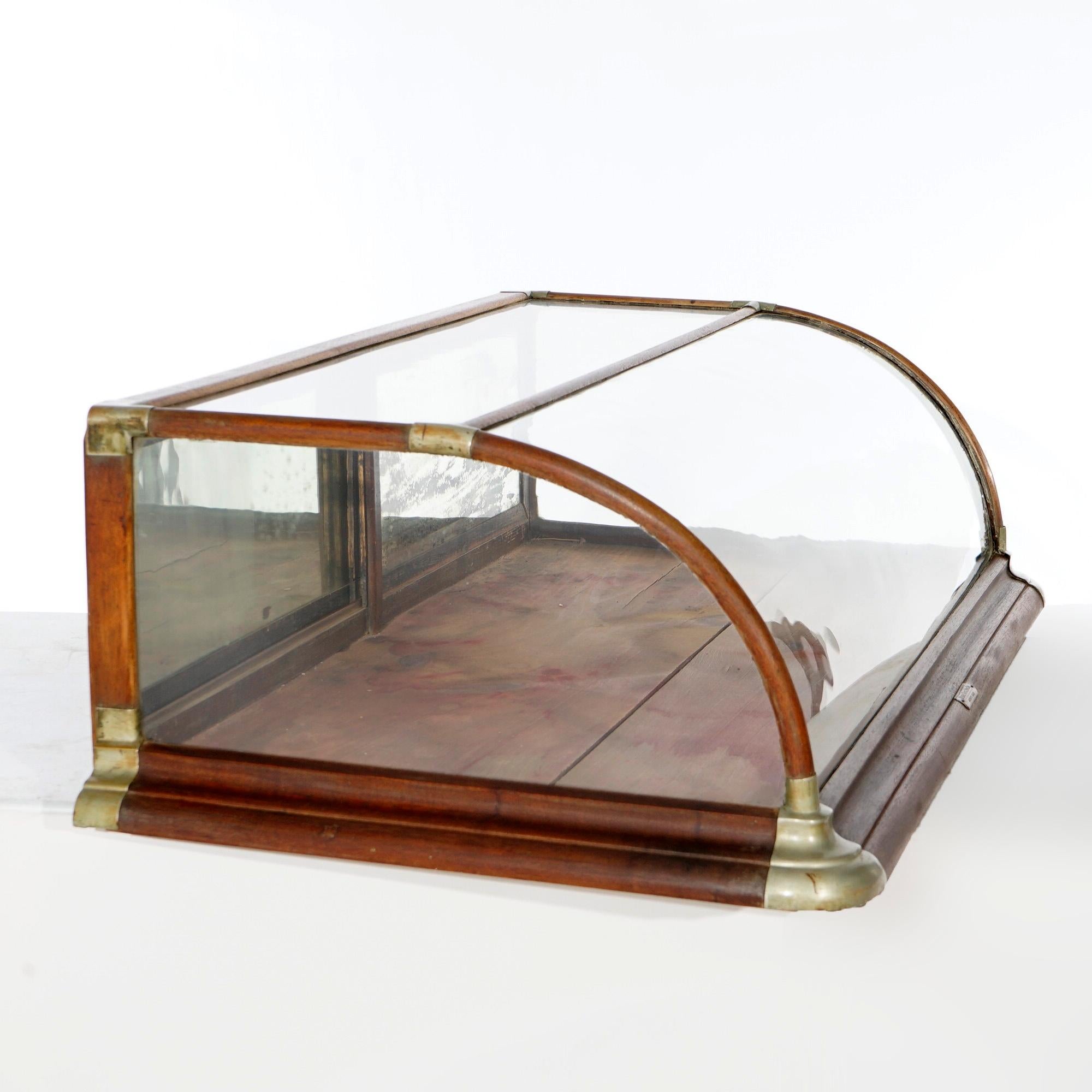 An antique country store table top display case by Burge Huck Manufacturing in Quincy, Illinois offers oak construction with curved glass front and sliding access doors, c1900

Measures- 14'' H x 48.25'' W x 26.75'' D.

*Ask about DISCOUNTED