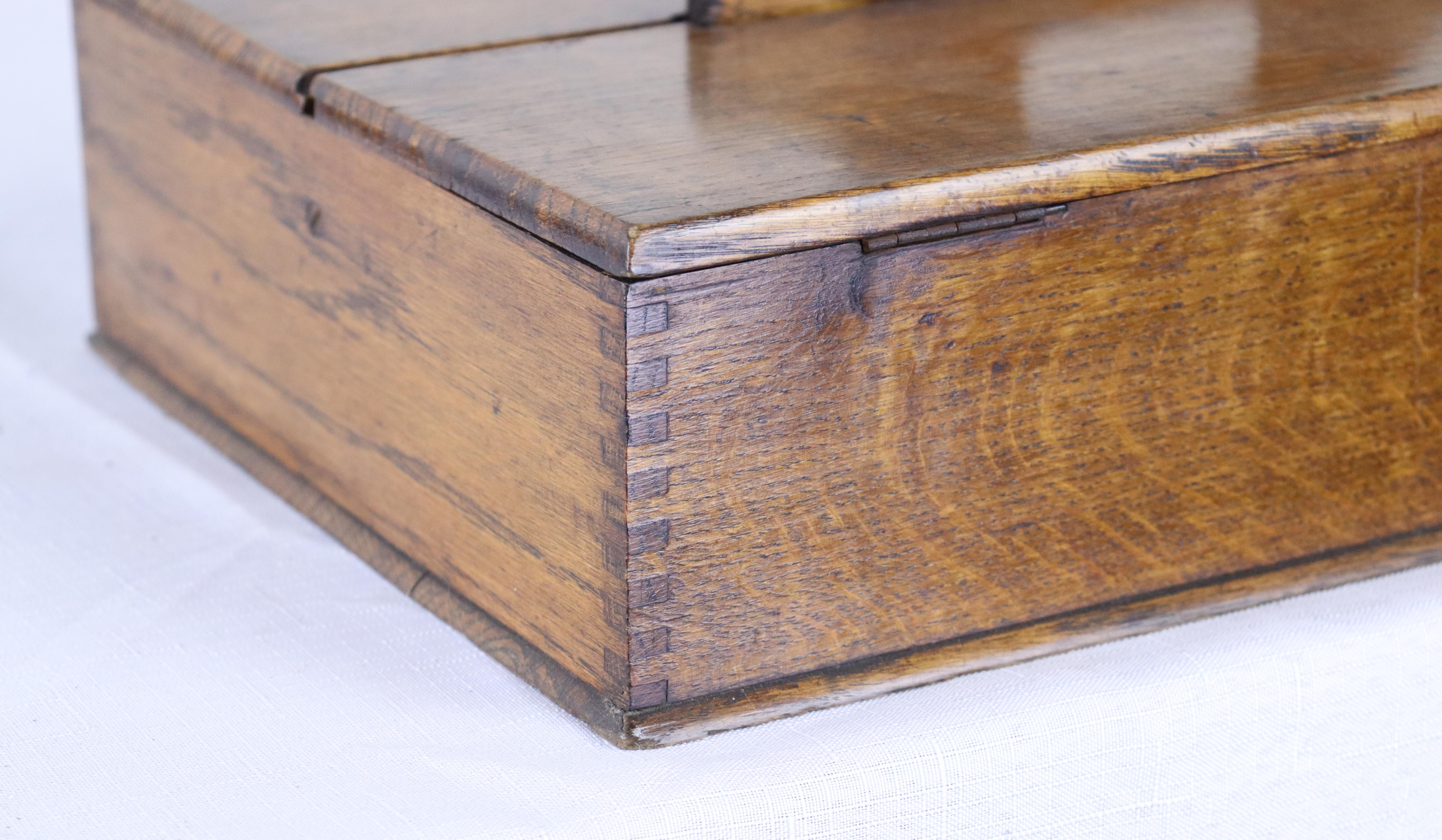 An antique cutlery box with wonderful dovetailed exterior corners in very good antique condition. The patina and color of the Golden oak is lovely. Would be useful for art supplies, kitchen utensils, or small collections. Charming!