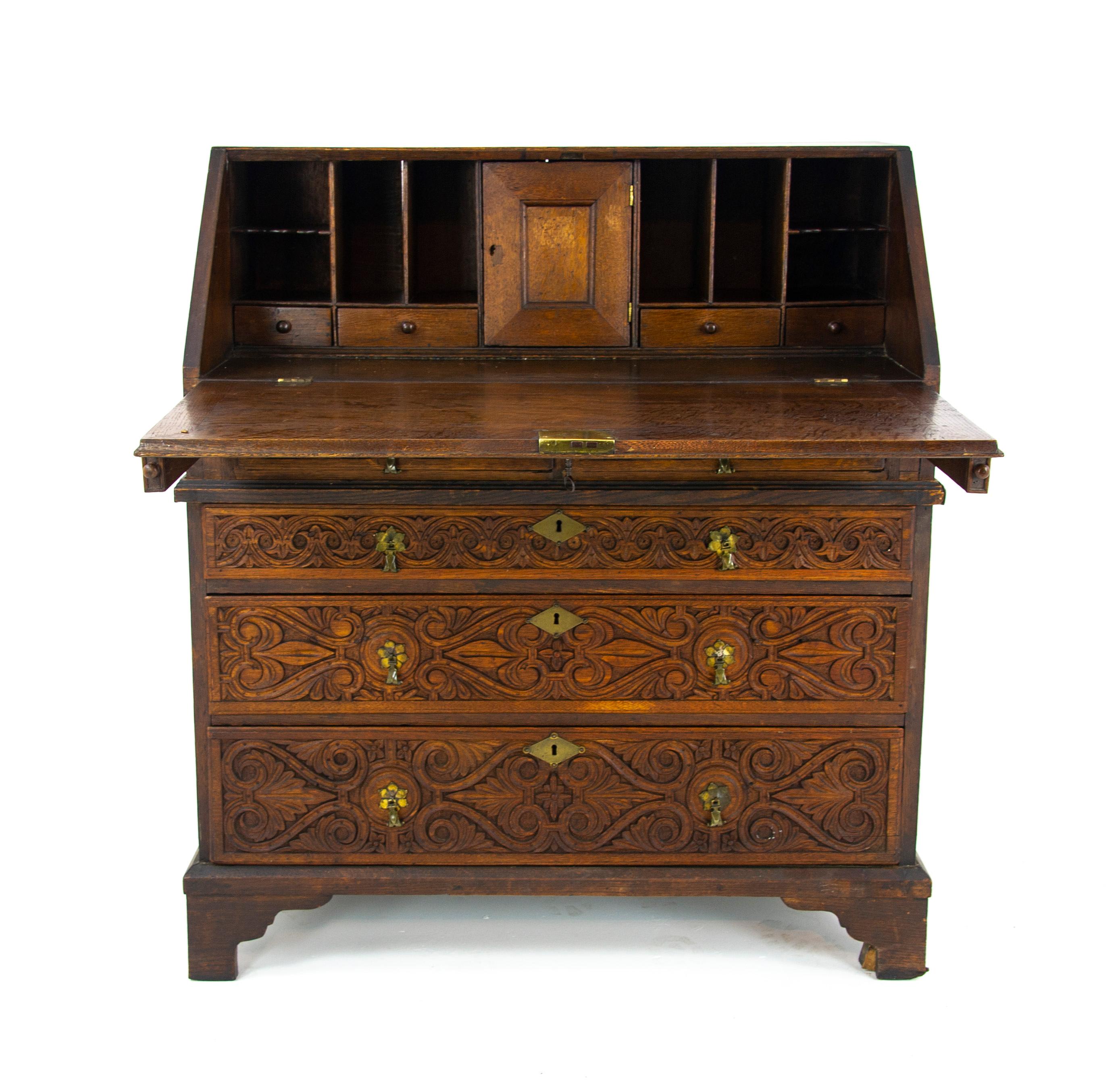Antique oak desk, 18th century carved oak slant front bureau, Antique furniture, Scotland 1780, B1446

Scotland 1780
All original condition
Rectangular top
Fall front with figural carving and brass escutcheon
Opens to reveal eight pigeon