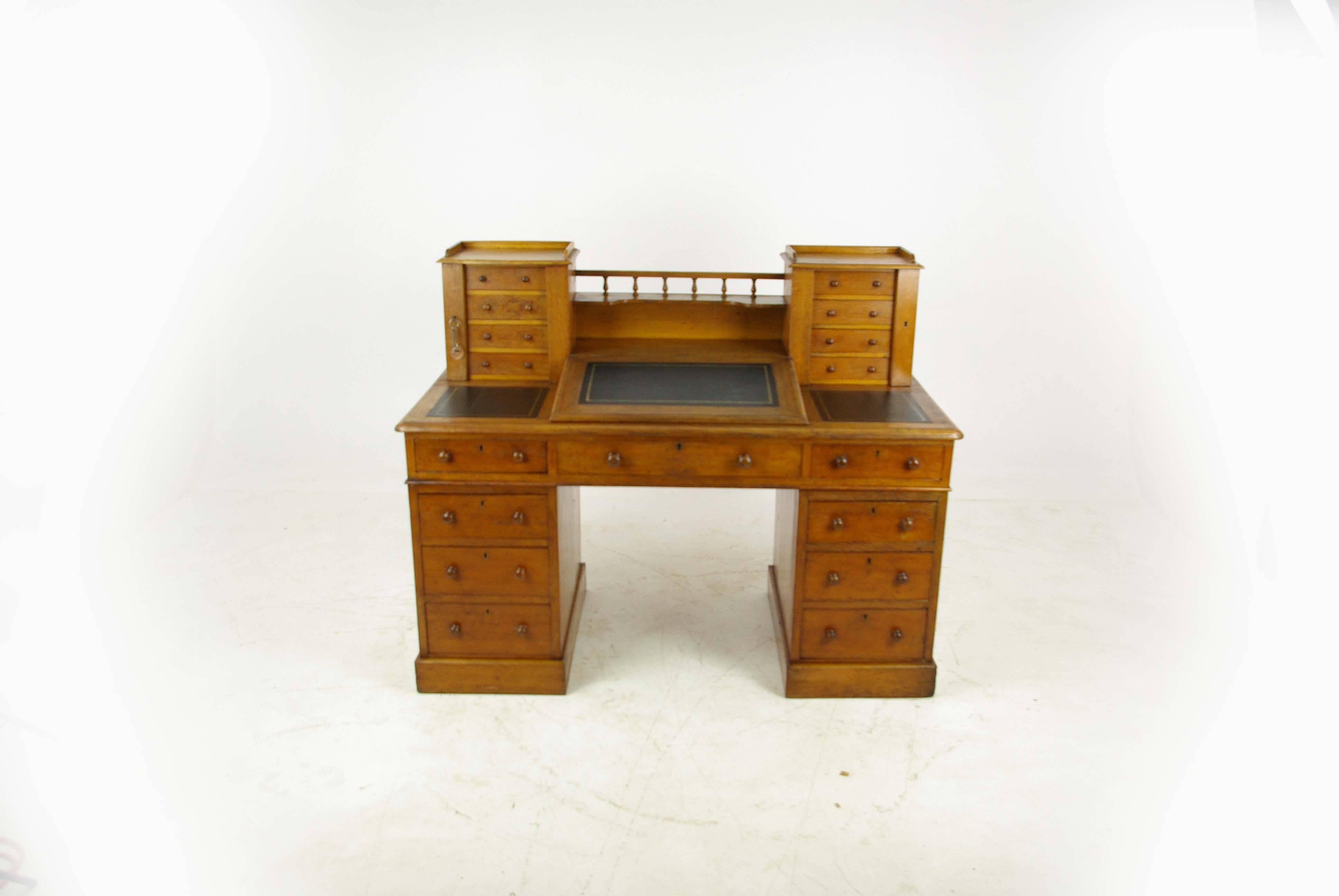 Antique oak desk, slant front desk, Dickens desk, England, 1880, Antique Furniture, B994.

England 1880,
Very nice example of a Victorian Oak Dickens Desk
Top with central spindled gallery
Flanked by two flights of four small drawers
Secured with