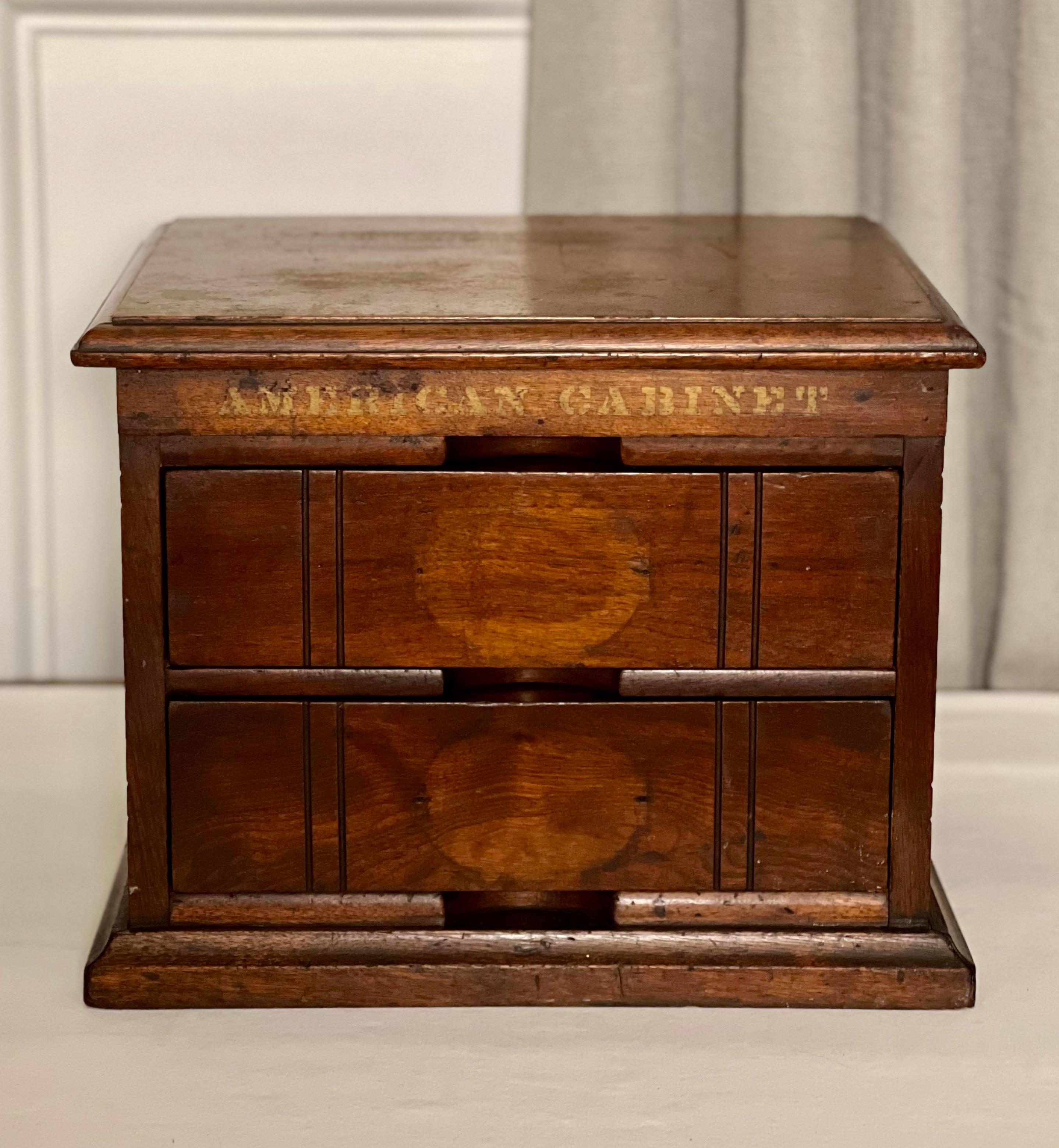 Antique Arts and Crafts letter-size oak desktop file cabinet by American Cabinet Company, c. 1900s.

Great little cabinet with two drawers ideal for a desk or tabletop. The drawers feature an open back, inset carved handles and are fitted with a