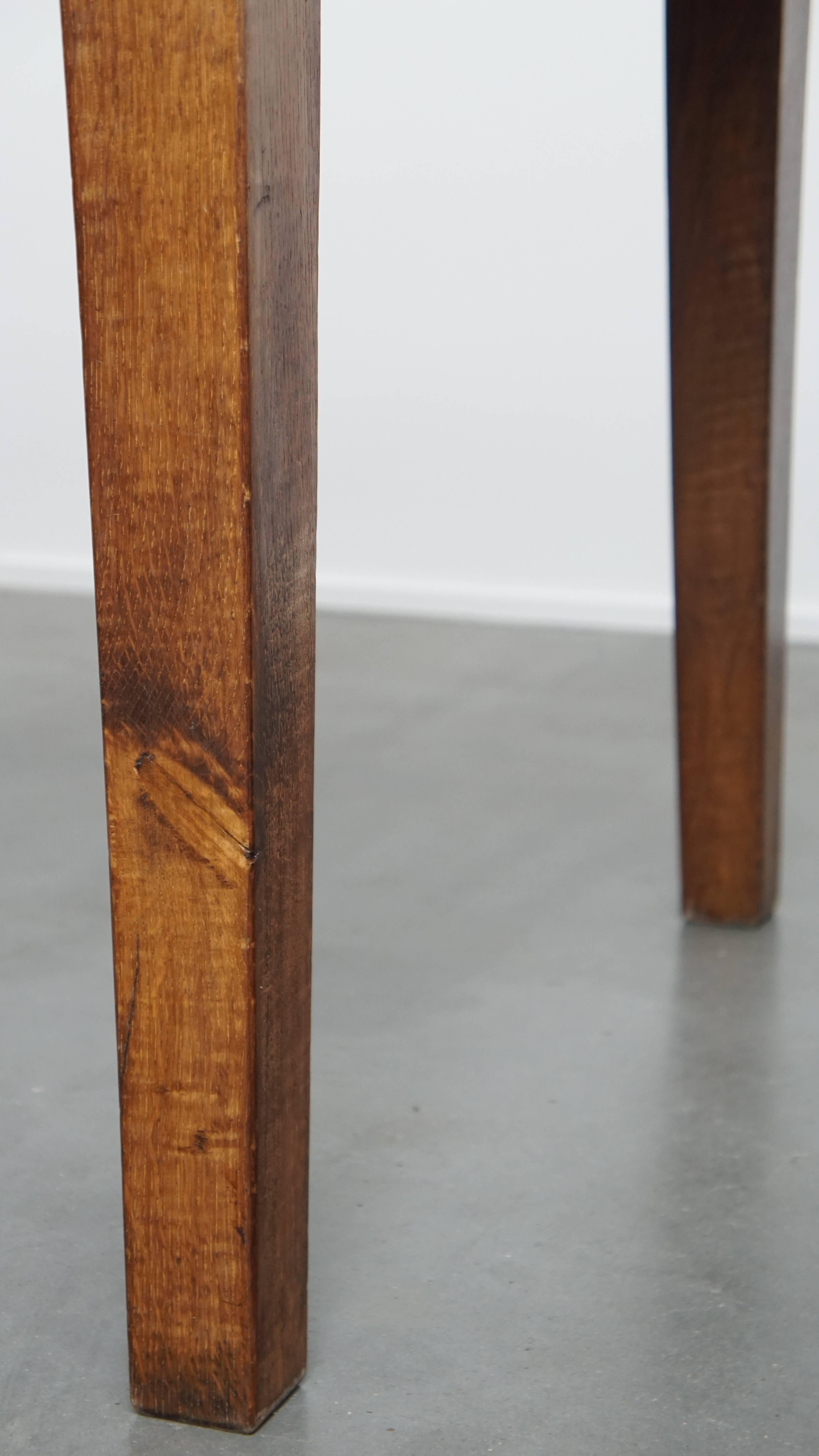 Antique oak dining table from early 1900 with a drop-leaf on one side For Sale 11