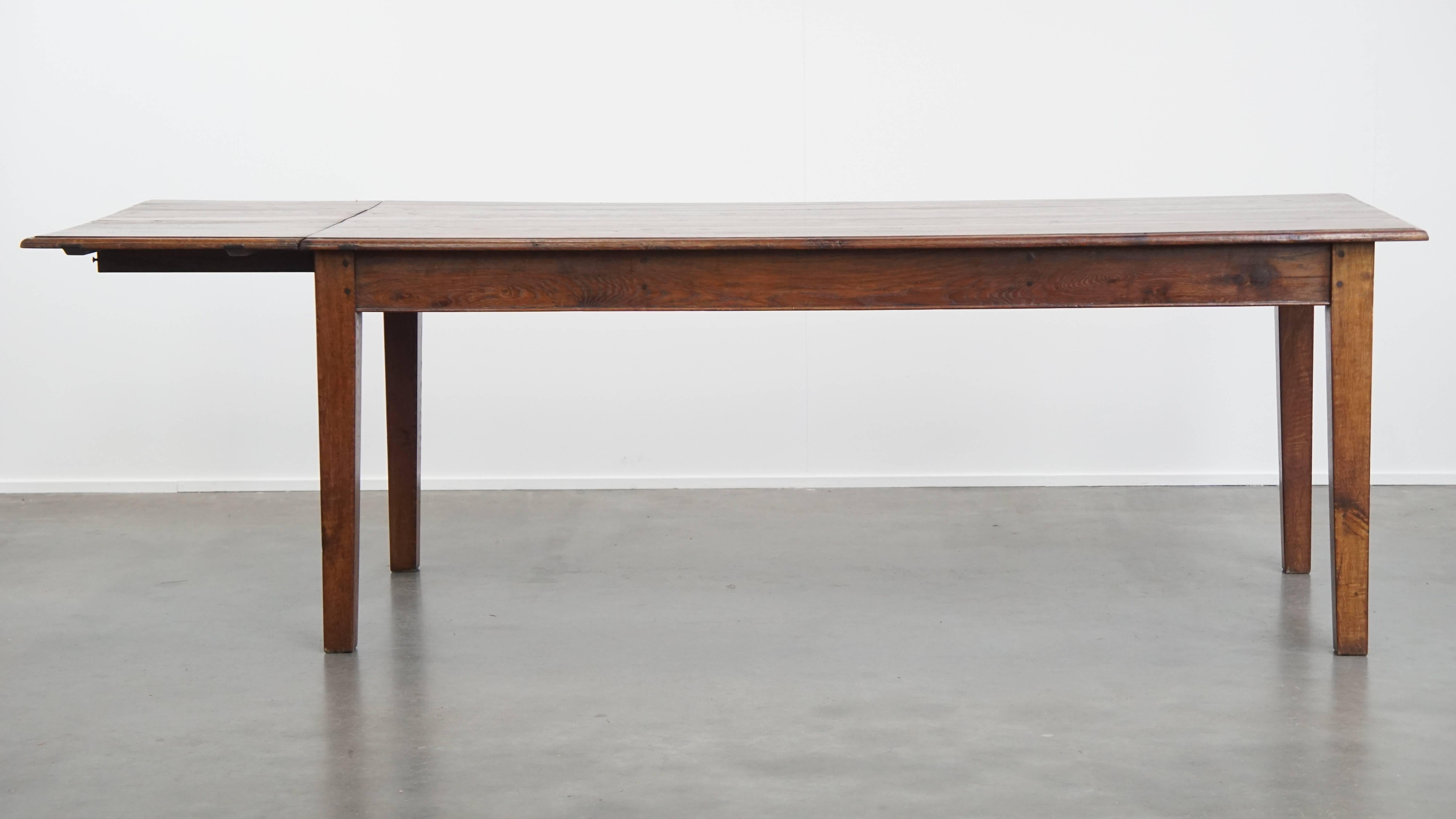 Classical Roman Antique oak dining table from early 1900 with a drop-leaf on one side For Sale