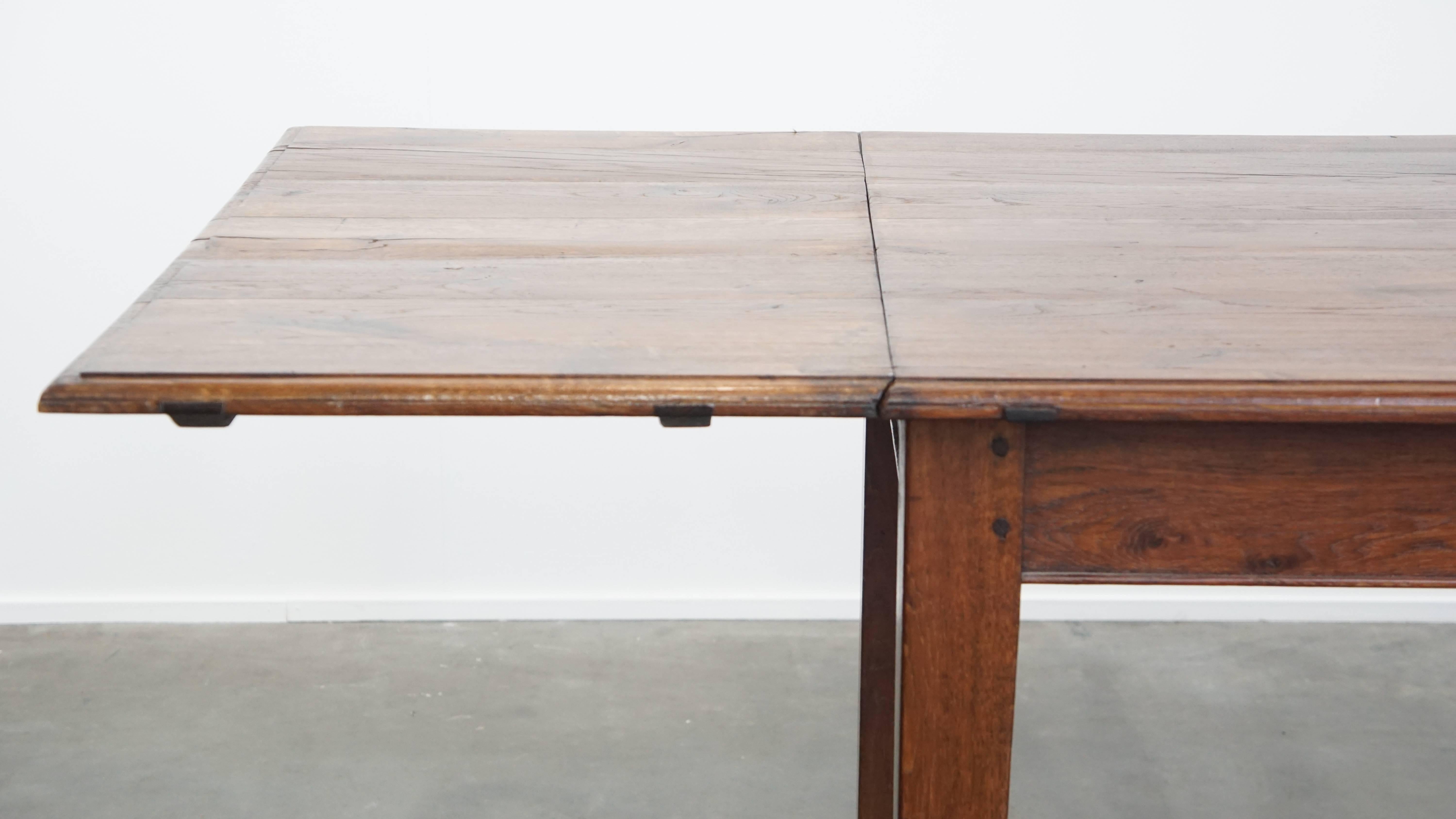Hand-Crafted Antique oak dining table from early 1900 with a drop-leaf on one side For Sale