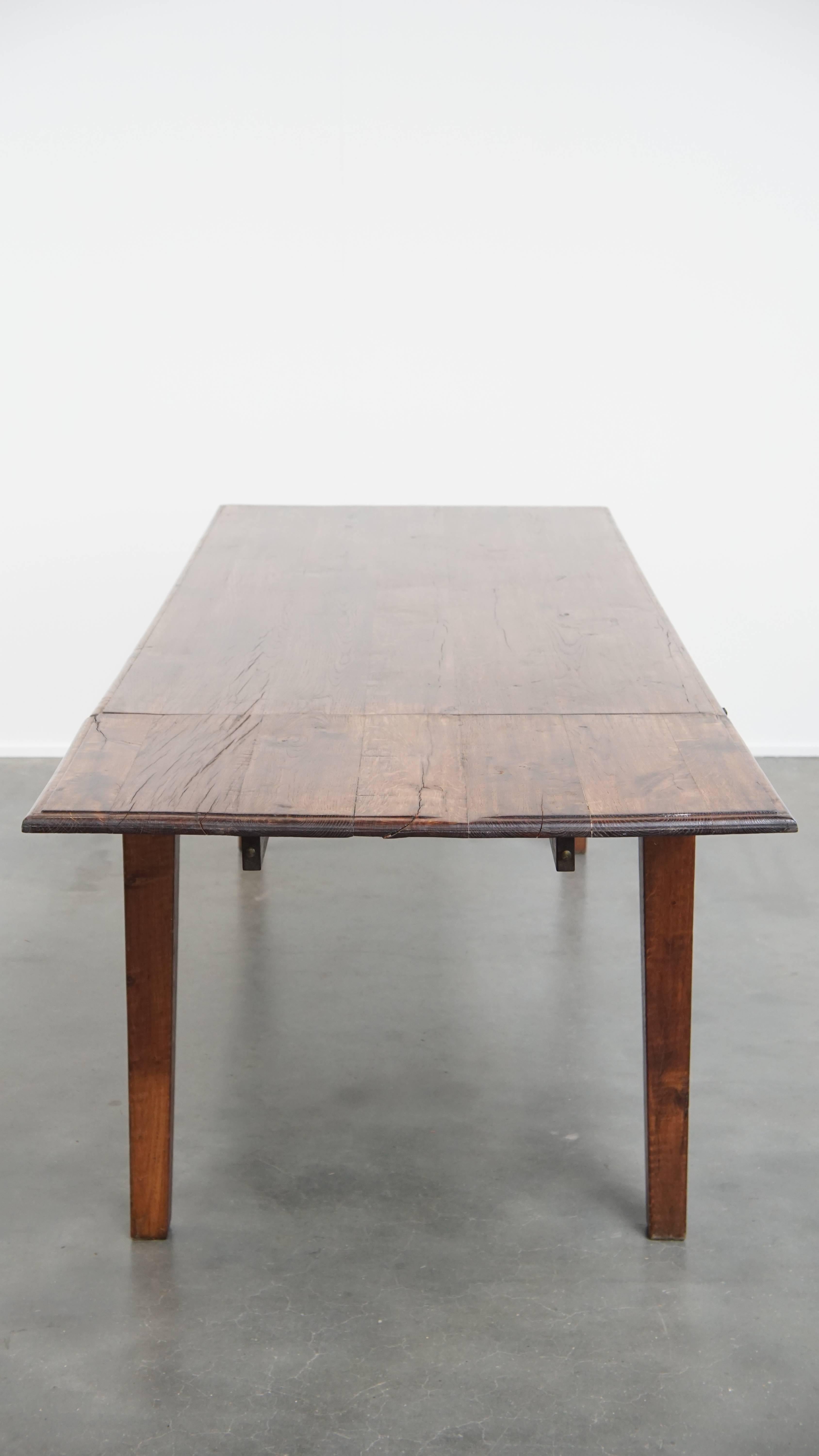 Wood Antique oak dining table from early 1900 with a drop-leaf on one side For Sale