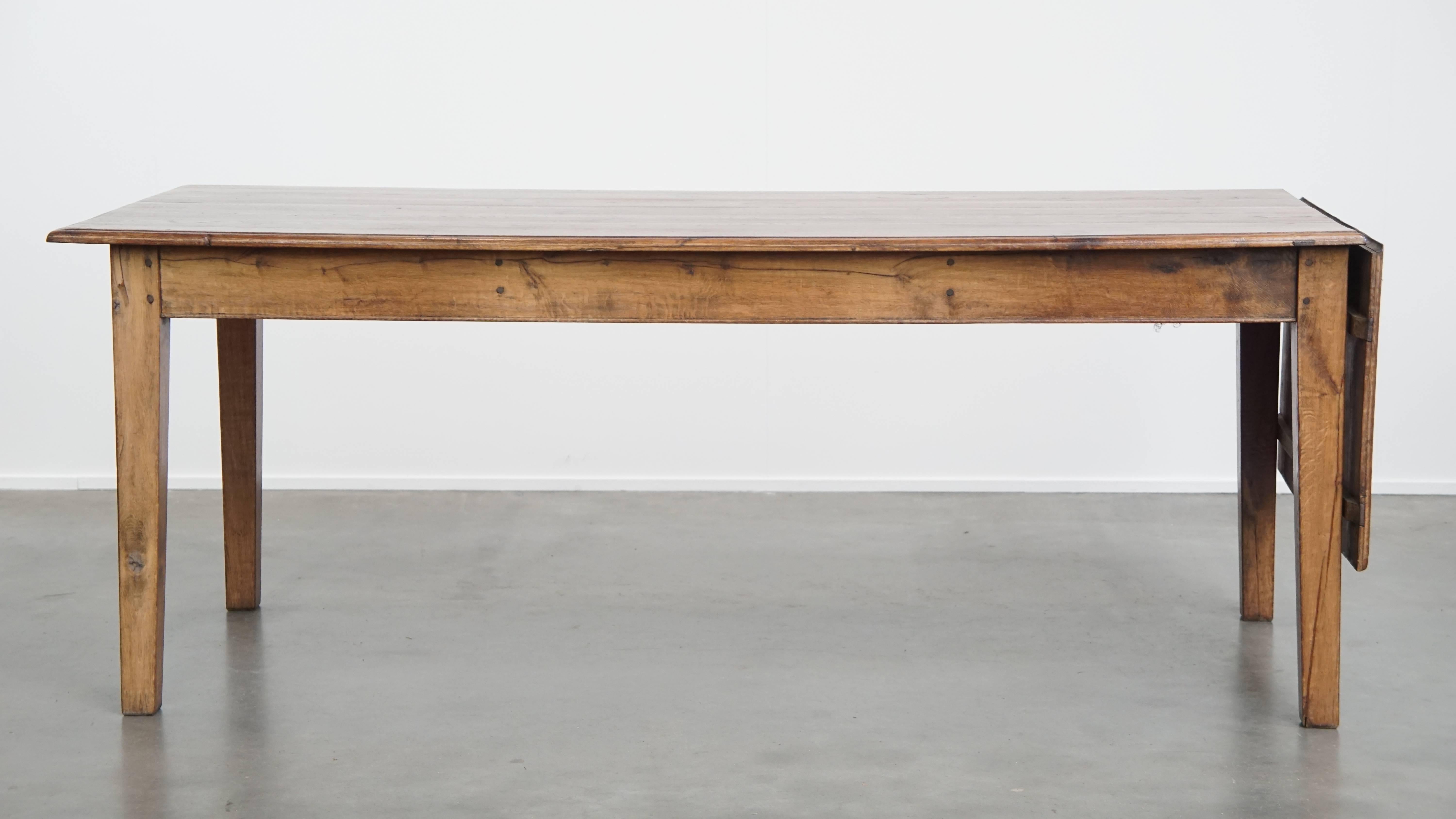 Antique oak dining table from early 1900 with a drop-leaf on one side For Sale 1