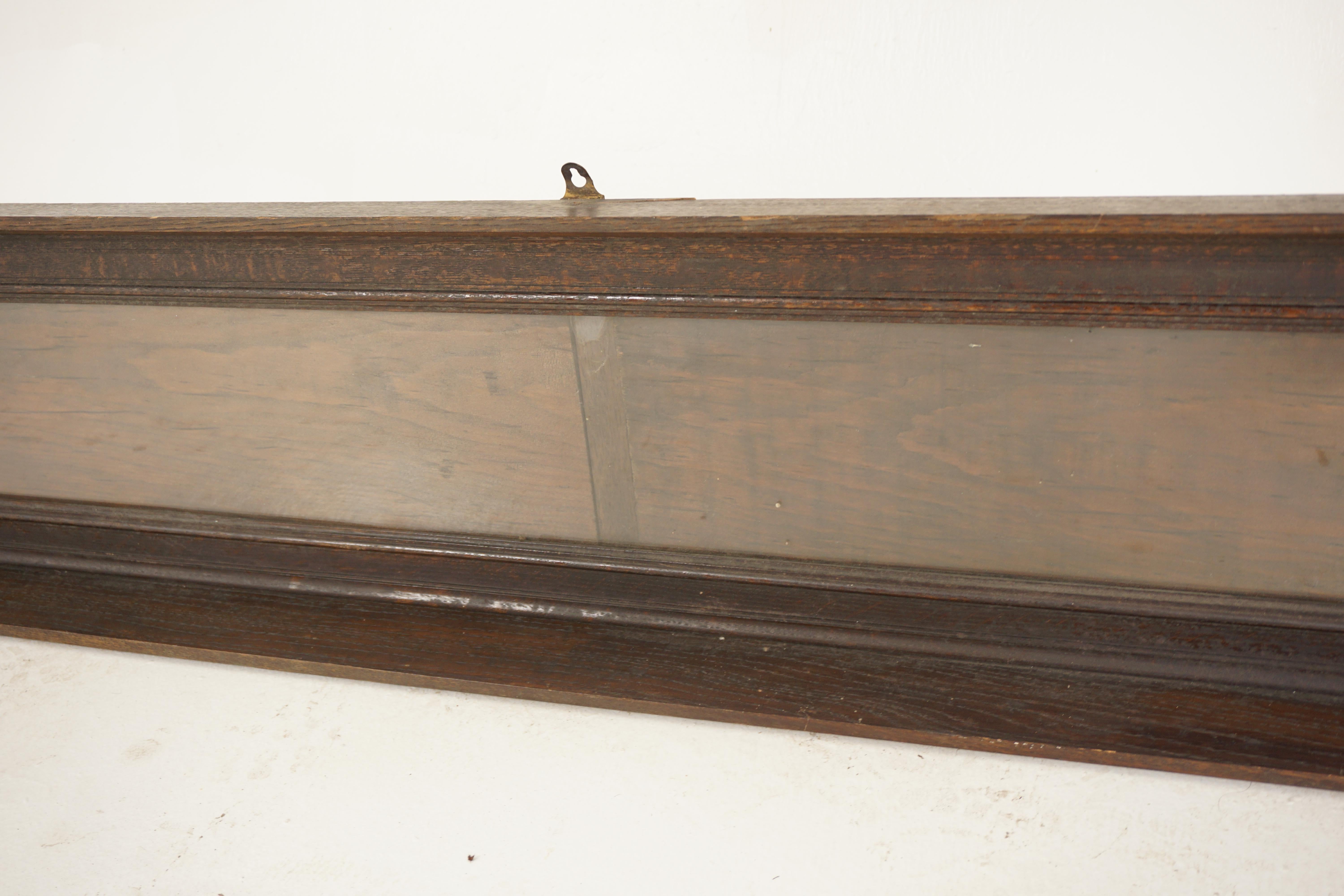 Antique oak display haberdashery cabinet, shop fitting, Scotland 1880, H414

Scotland 1880
Solid oak
Original finish
Very long shallow glass fronted cabinet
Moulded cornice on top
Glass front with a shelf below
Has three hanging fittings on