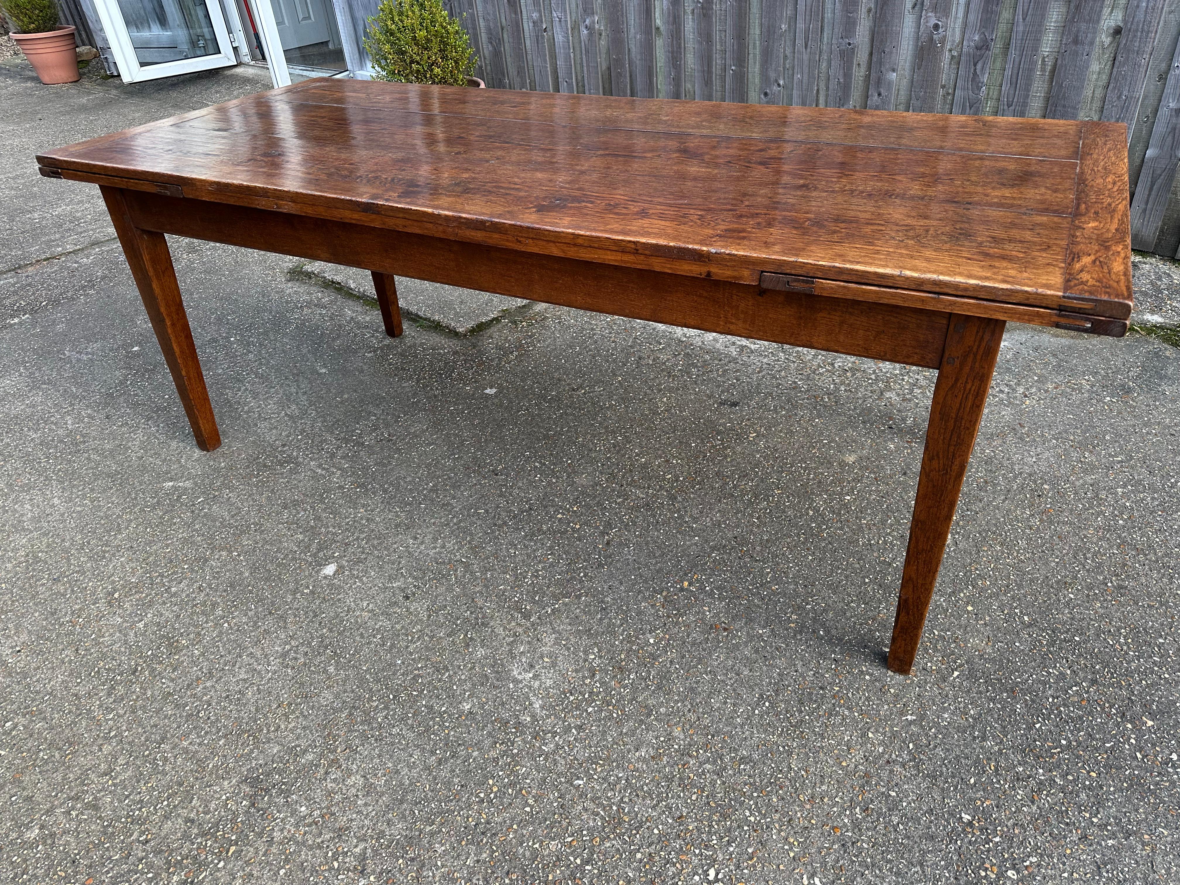 Antique Oak Double Extending Table, the table stands on a sturdy apron and four tapered legs. Lovely colour and patina and great at this width. The table opens up to 102.5