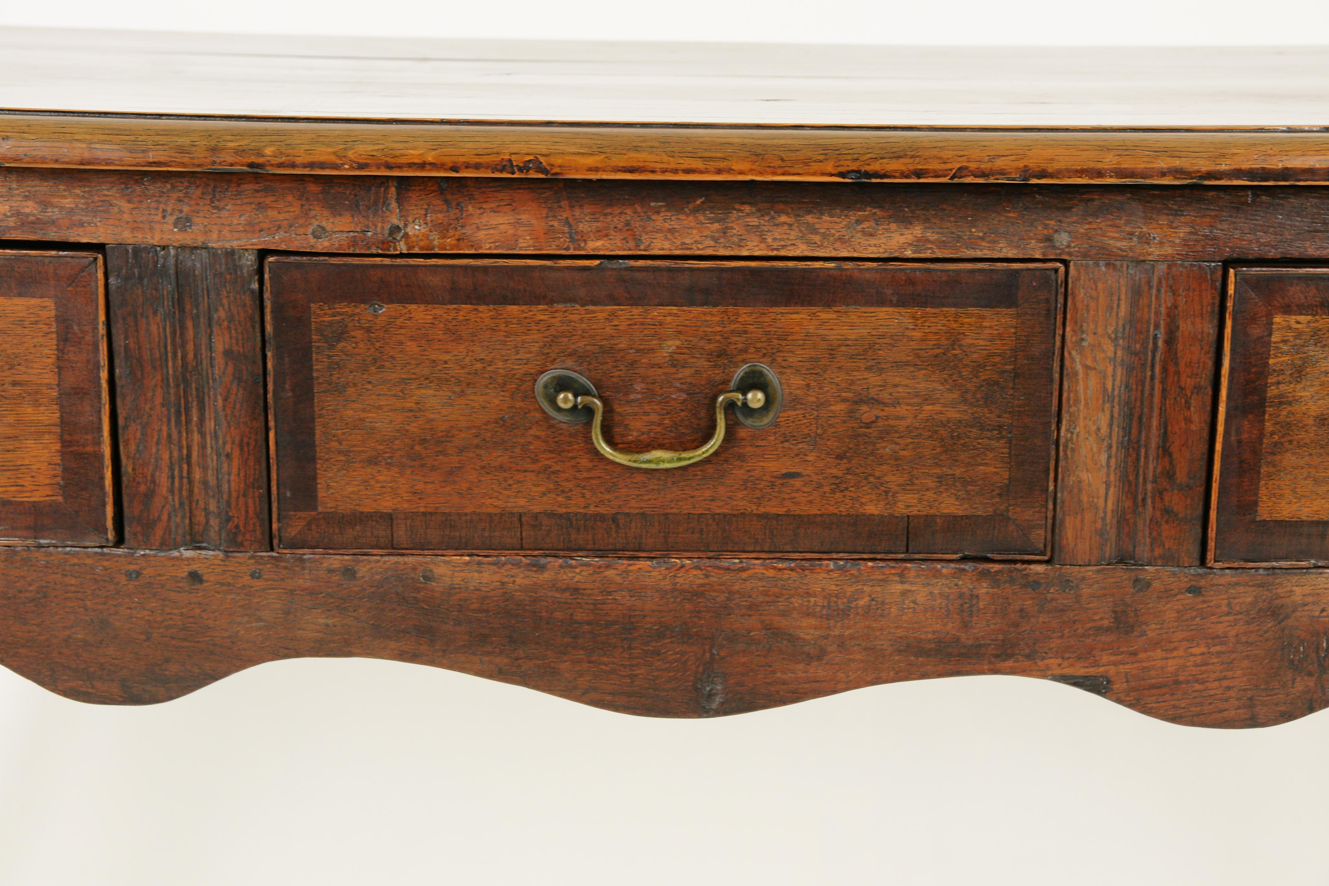 Antique oak dresser base, Georgian sideboard, Antique Furniture, Scotland 1790, B1668

Scotland 1790
Oak moulded top
Three original cross bonded drawers with old hardware (not original)
Shaped apron below
Panelled sides
Supported by tall