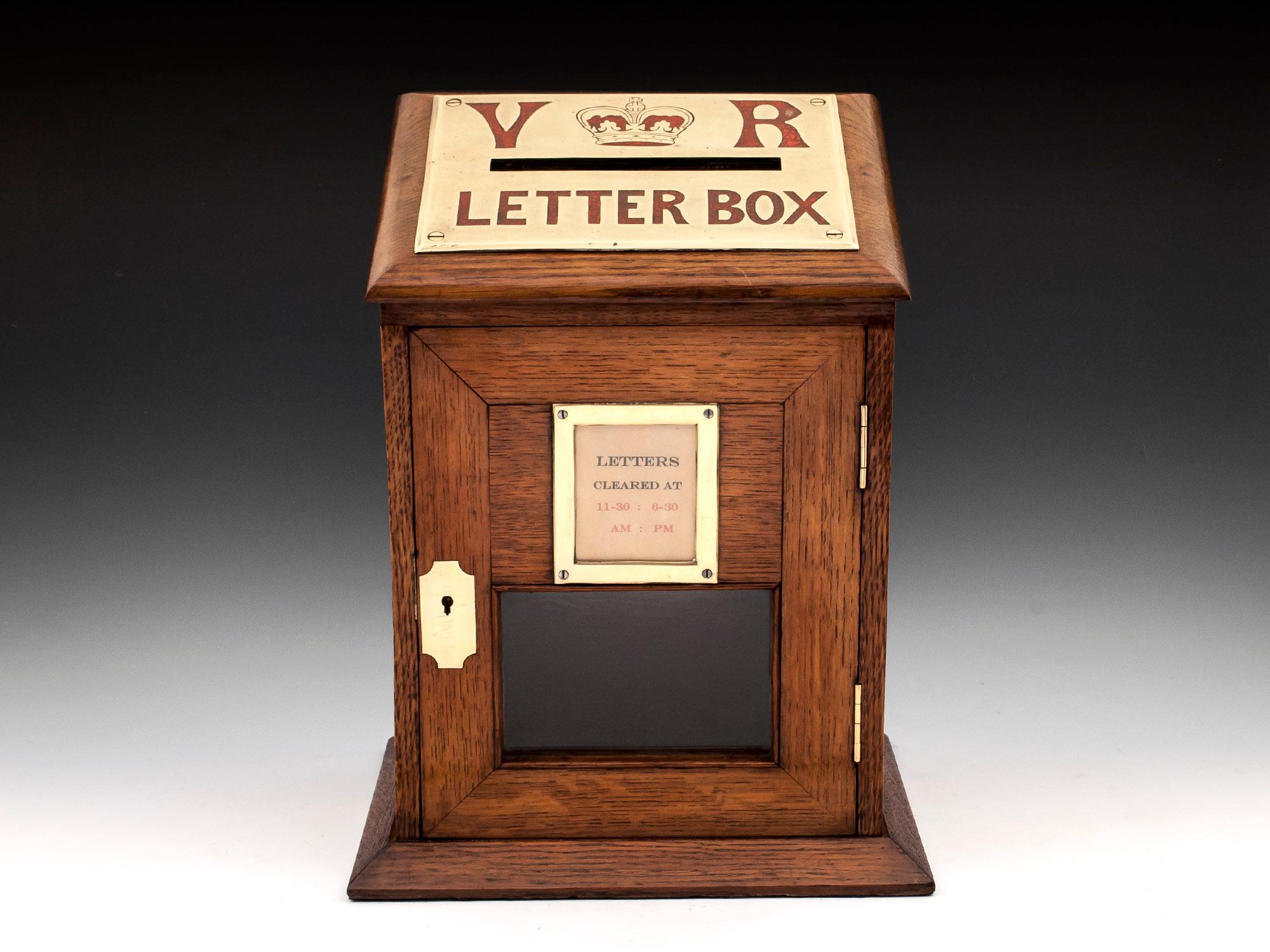 Country house letter box made of solid oak with an engraved brass letter slot with red letters V & R (Victoria Regina) with a crown of Queen Victoria and the words 