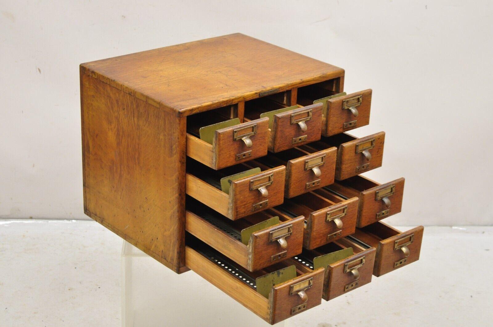 Antique Oak Euro SoleMakers Card Catalog 12 Drawer Apothecary File Cabinet. Item features a dovetail constructed case, quartresawn oak wood, original brass hardware, original brass tag, very nice antique item.  Circa Early 1900s. Measurements: 16