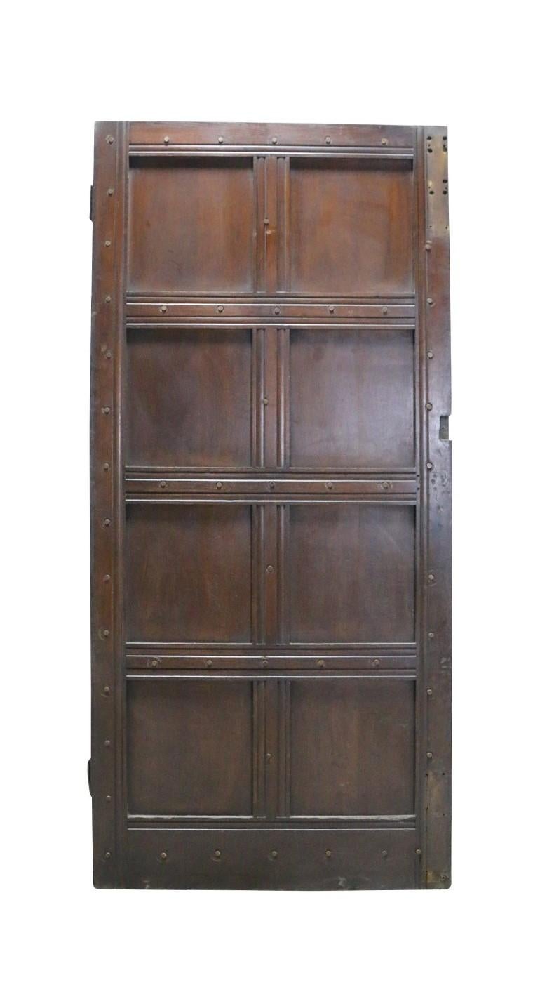 A reclaimed exterior oak door of eight panel configuration.