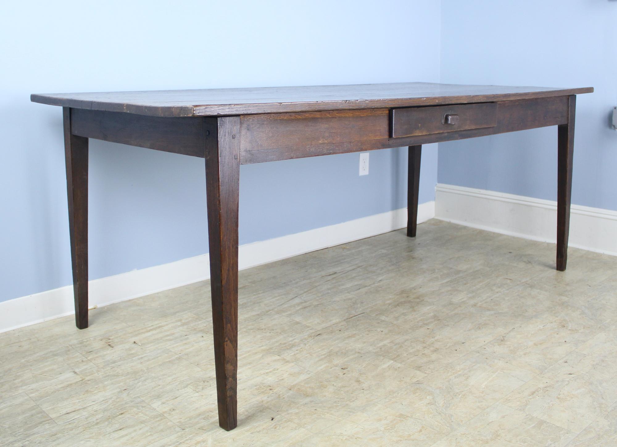 A nicely proportioned oak farm table. Very good grain, color and patina, with one natural knot hole on the top. 26