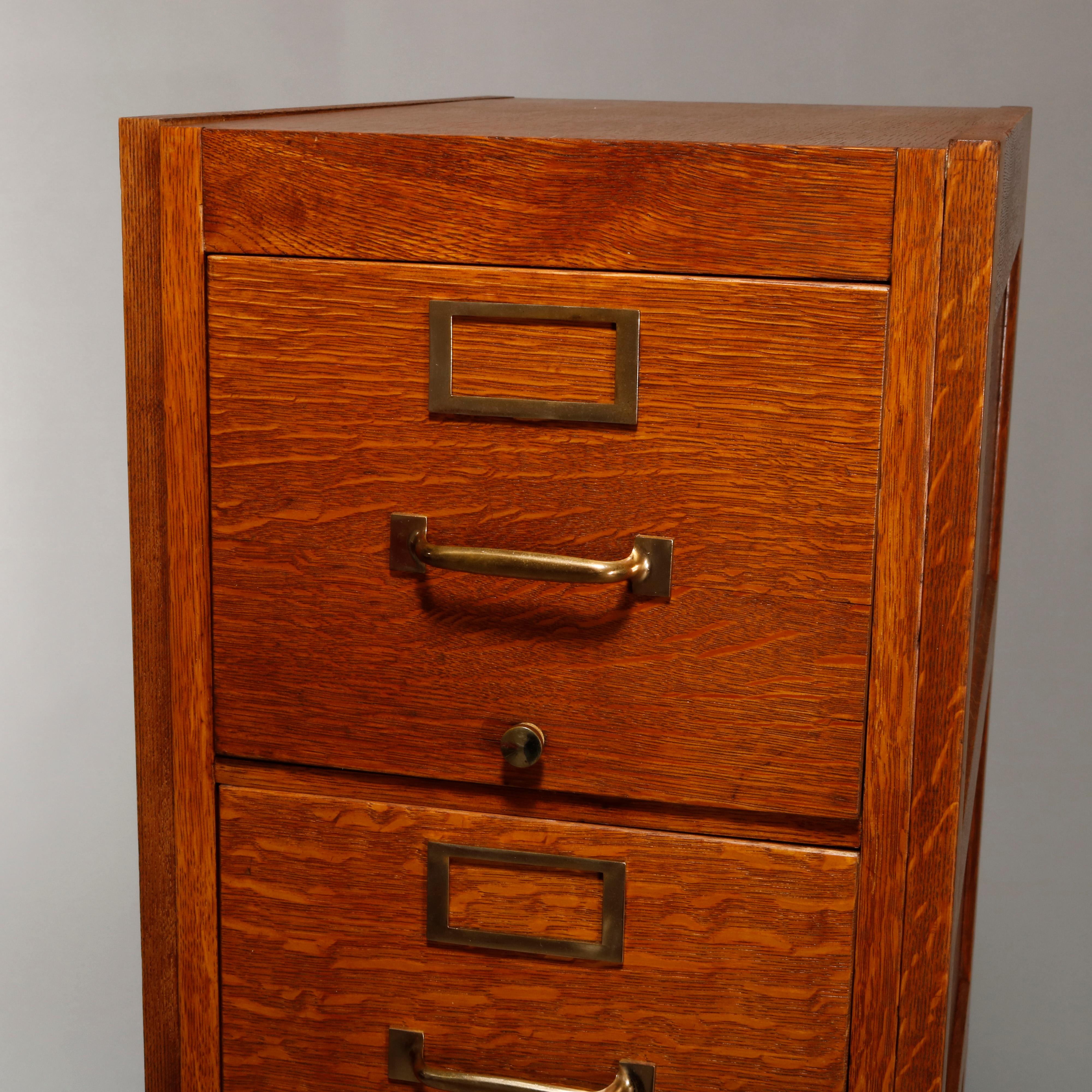 An antique file cabinet offers quarter sawn oak construction with paneled sides and five drawers, circa 1900.

Measures: 52.25