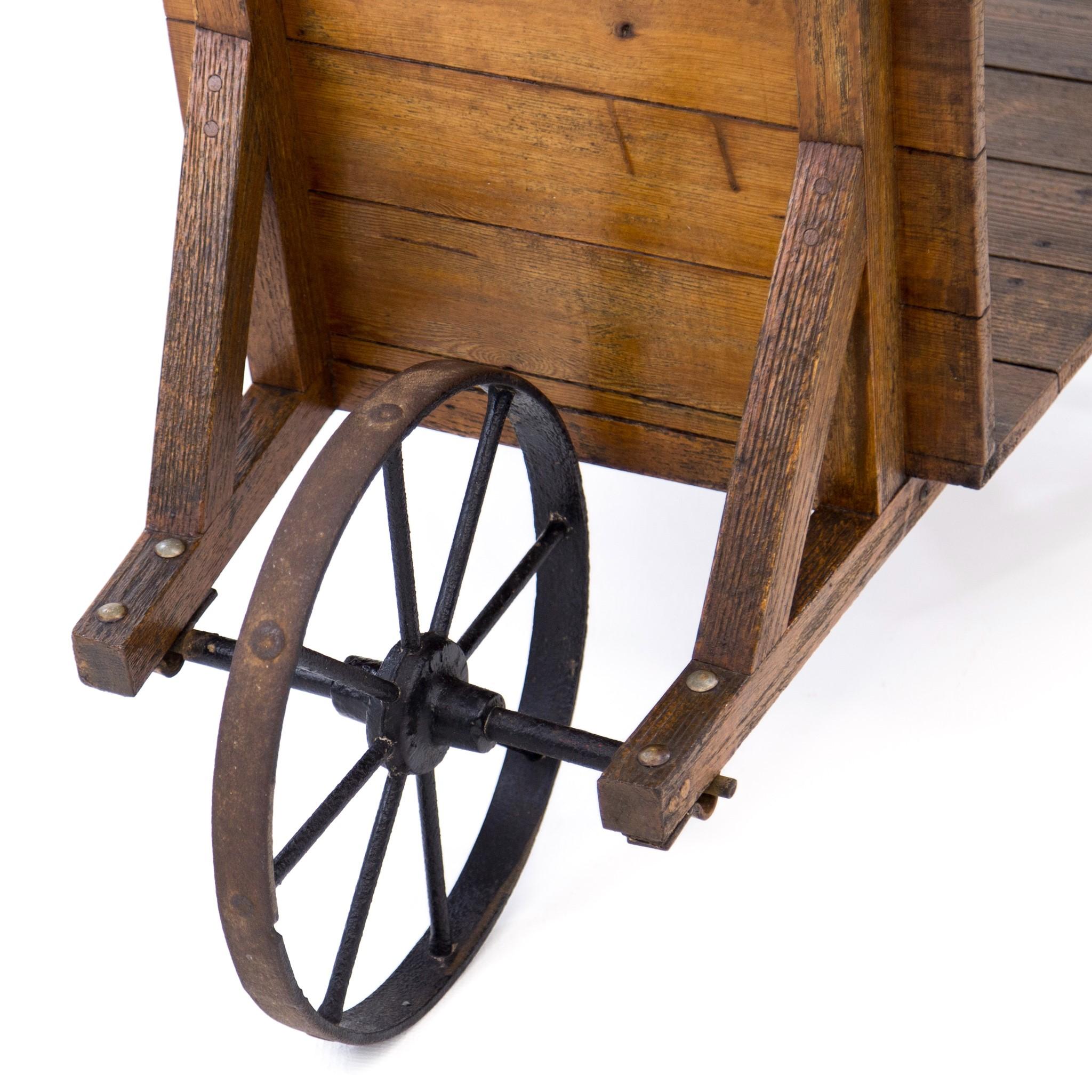 antique wooden wheelbarrow with metal wheel