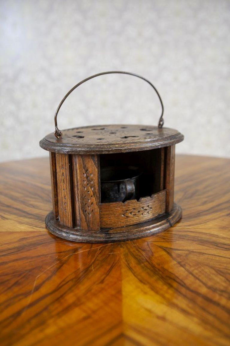 Antique Oak Foot Warmer From the beginning of 20th Century

An antique foot warmer made of oak wood. Inside, there is a compartment for hot coals, with a handle on the top part for easier carrying.