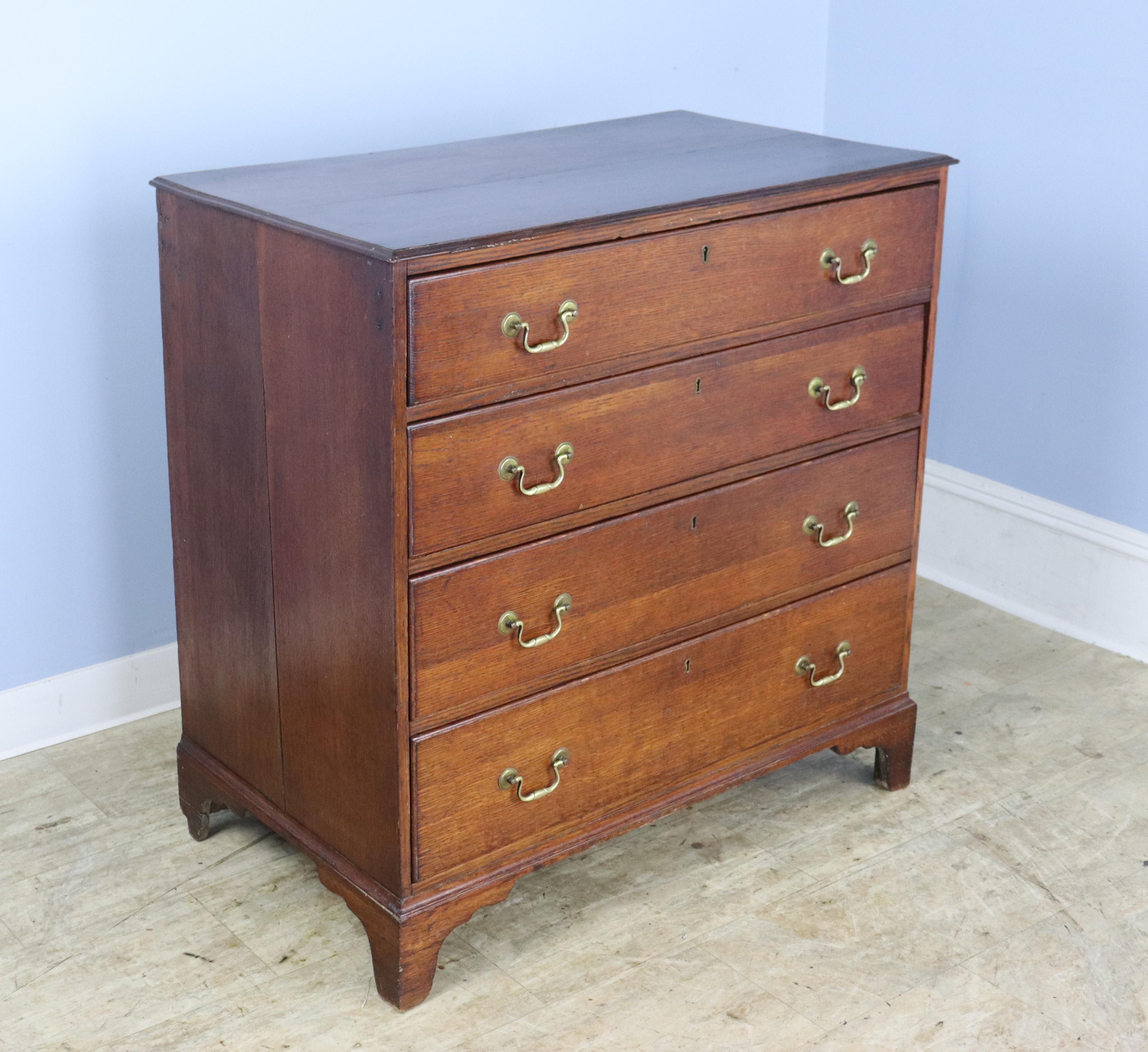 Beautiful original handles are a highlight of this terrific early oak dresser. Note the articulated ogee feet and charming keyholes. The smooth patinated top and the gentle moulded edge enhance the overall look. The bureau's warm color and lovely