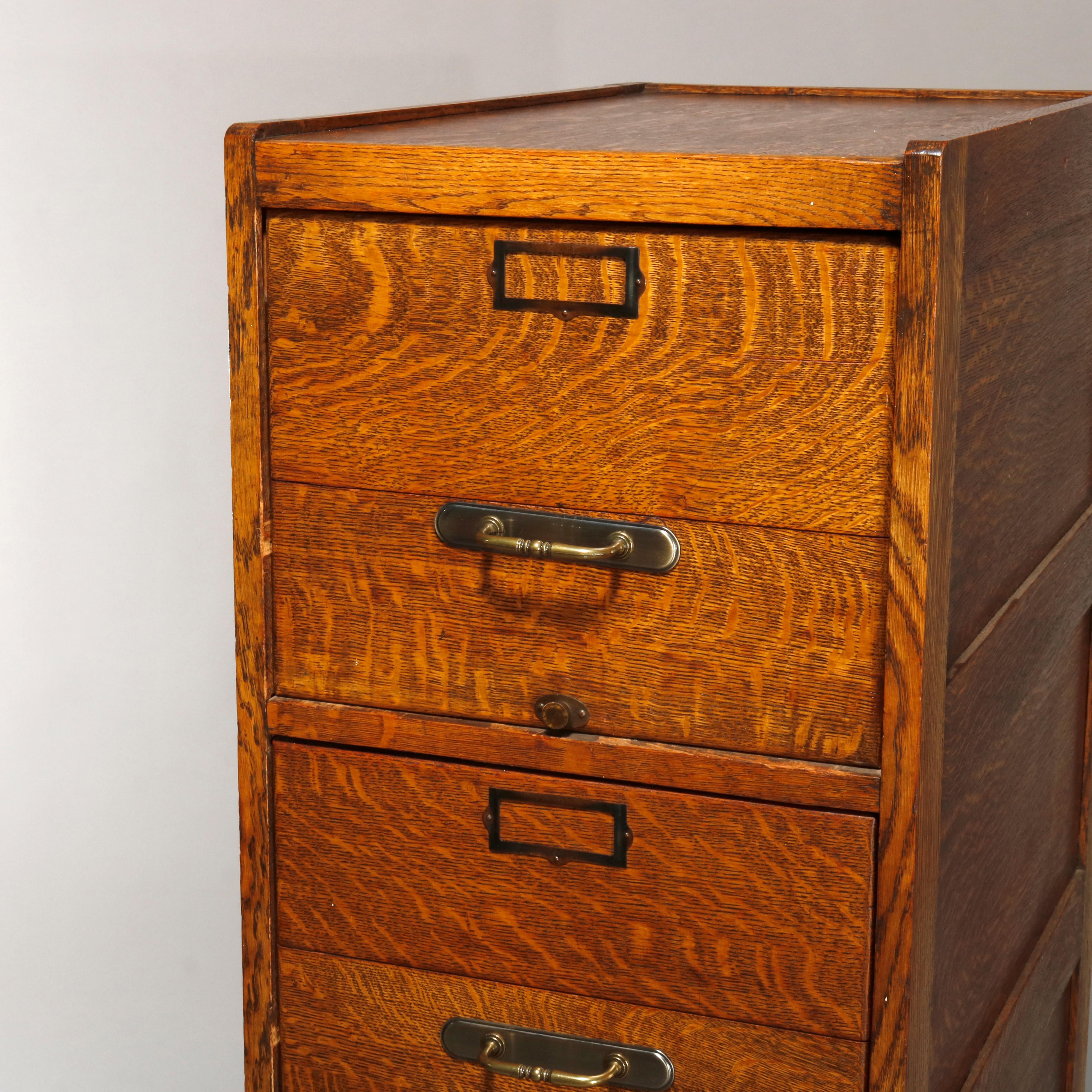An antique file cabinet offers quarter sawn oak construction with paneled sides and four drawers, circa 1900.

Measures: 50.5