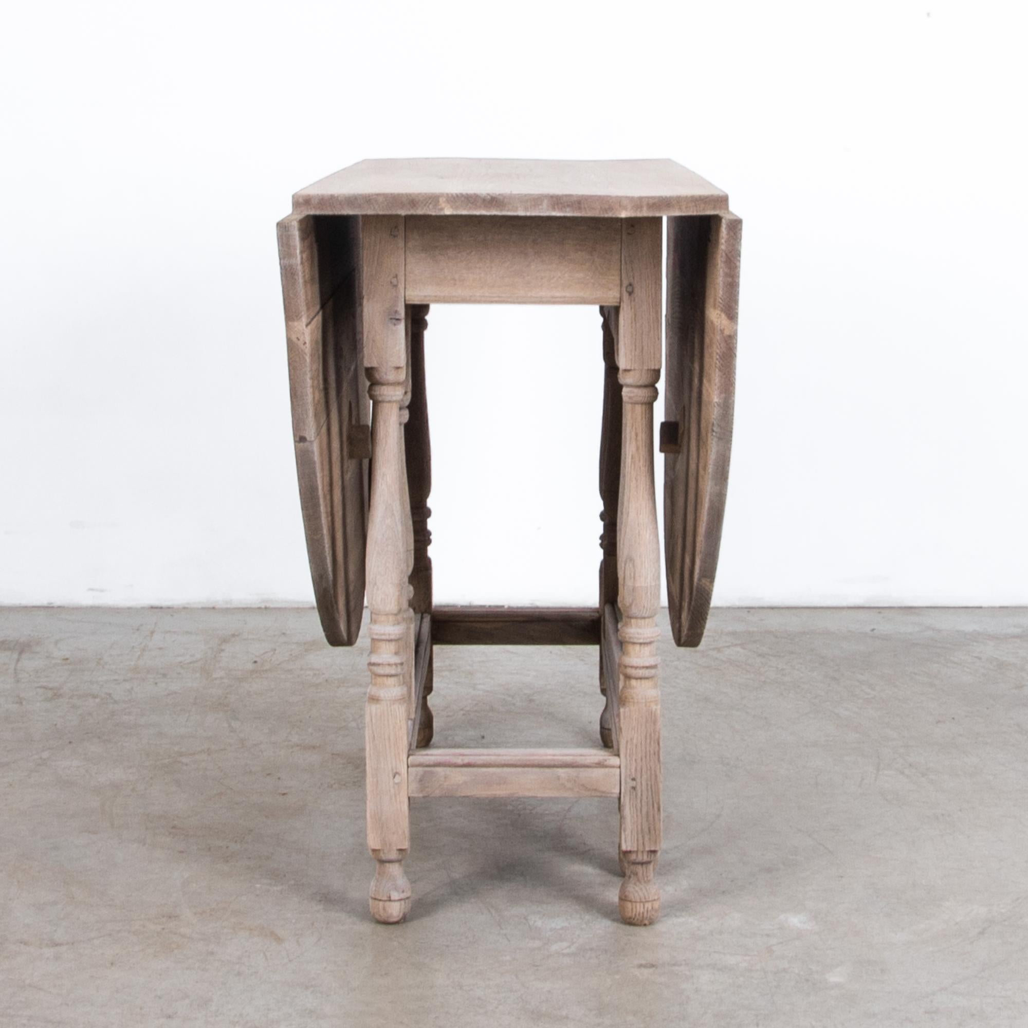A folding gate leg table from the United Kingdom, circa 1900. The folding gate leg makes this table versatile and practical while retaining stability, and style. Carved details and turned table legs give a classical inflection, “twisted barley