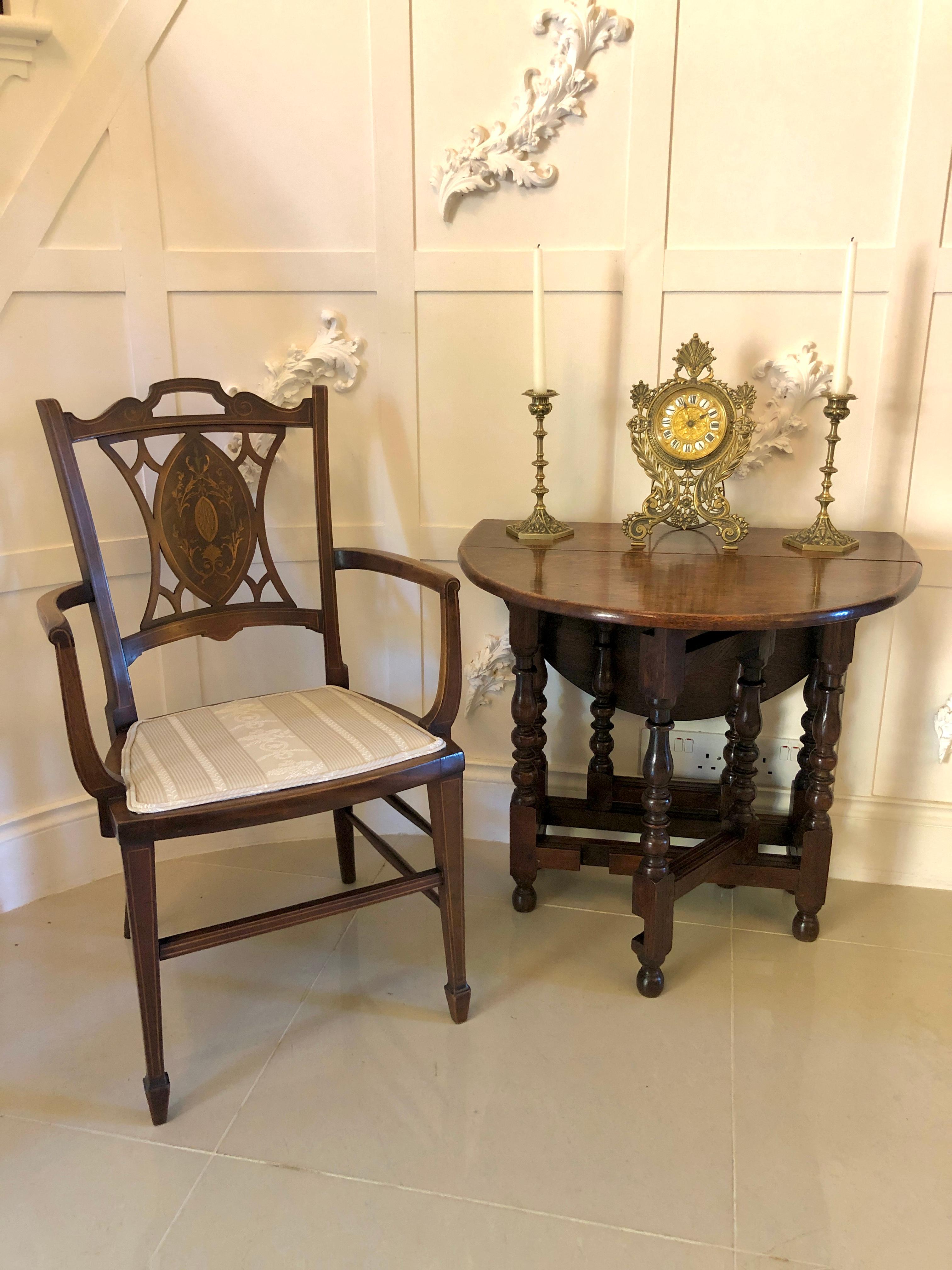 Antique oak gateleg table having a quality oak top with two drop leaves supported by delightful turned and shaped columns. It has two swing out gatelegs united by solid oaks stretchers and is raised on turned bun feet.

A splendid all original