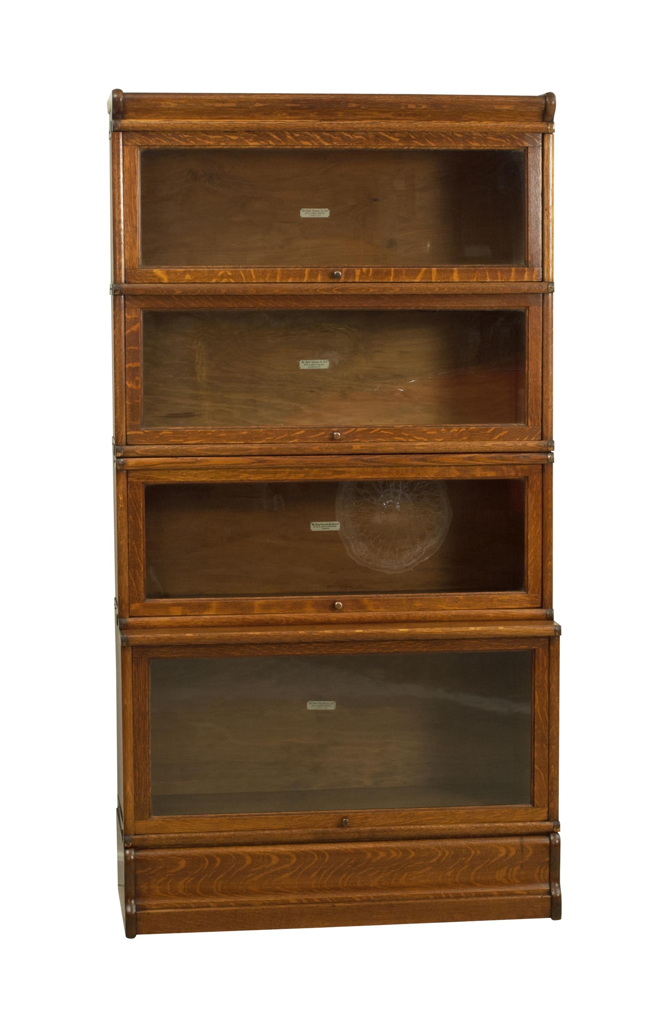 Oak Globe Wernicke bookcase, DVD cabinet.
Antique stacking or barrister's bookcase made by 'The Globe-Wernicke Co. Ltd, London'. The four sectional glazed bookcase with up and over single pane glazed doors, graduated four tier storage units with a