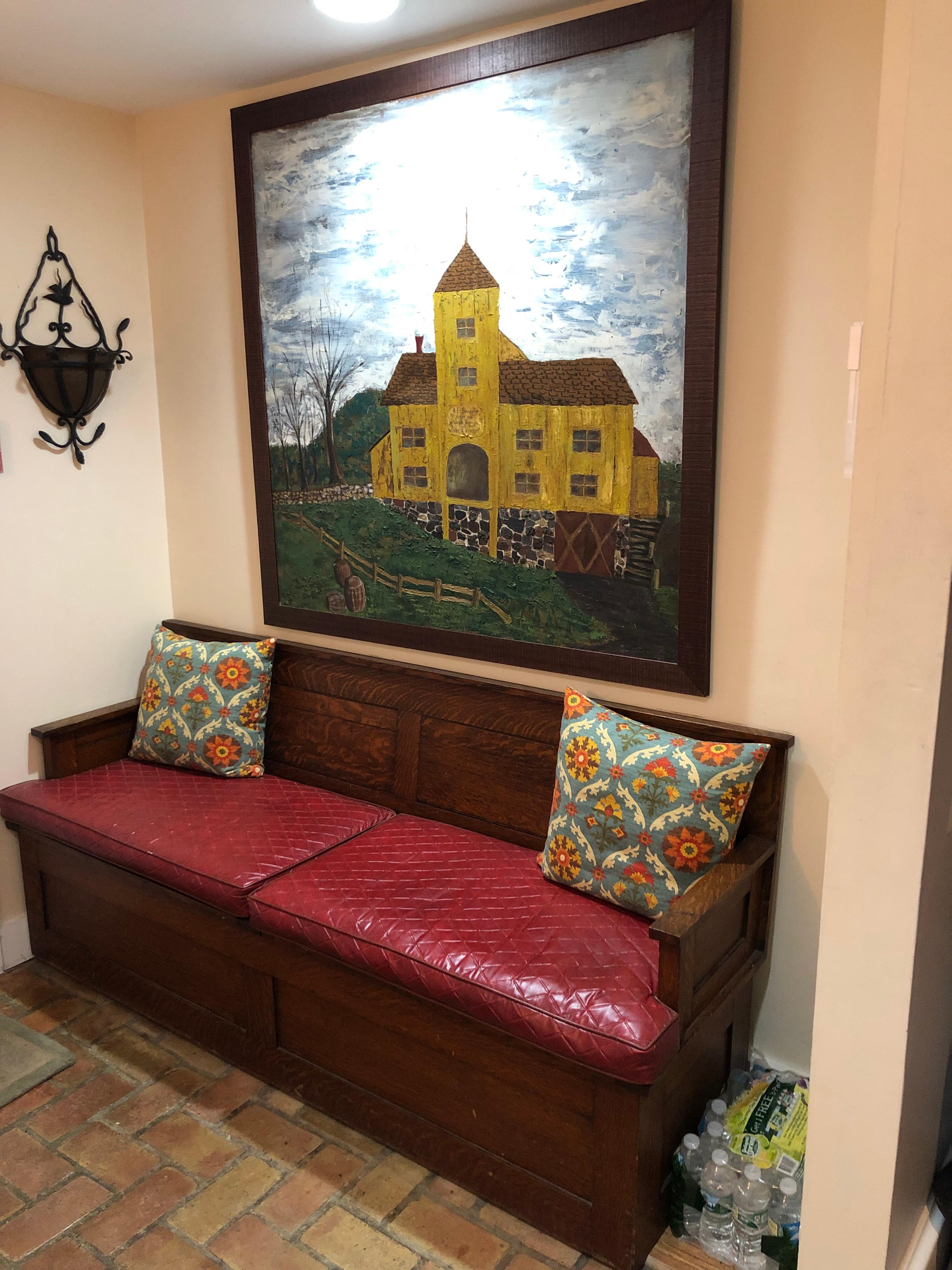 Antique oak hall bench with cushions and storage. Nice solid oak settle on castors so easy to move but very stable and does not roll around. Castors can also be removed. Two solid oak seats lift up for substantial storage underneath. Perfect for