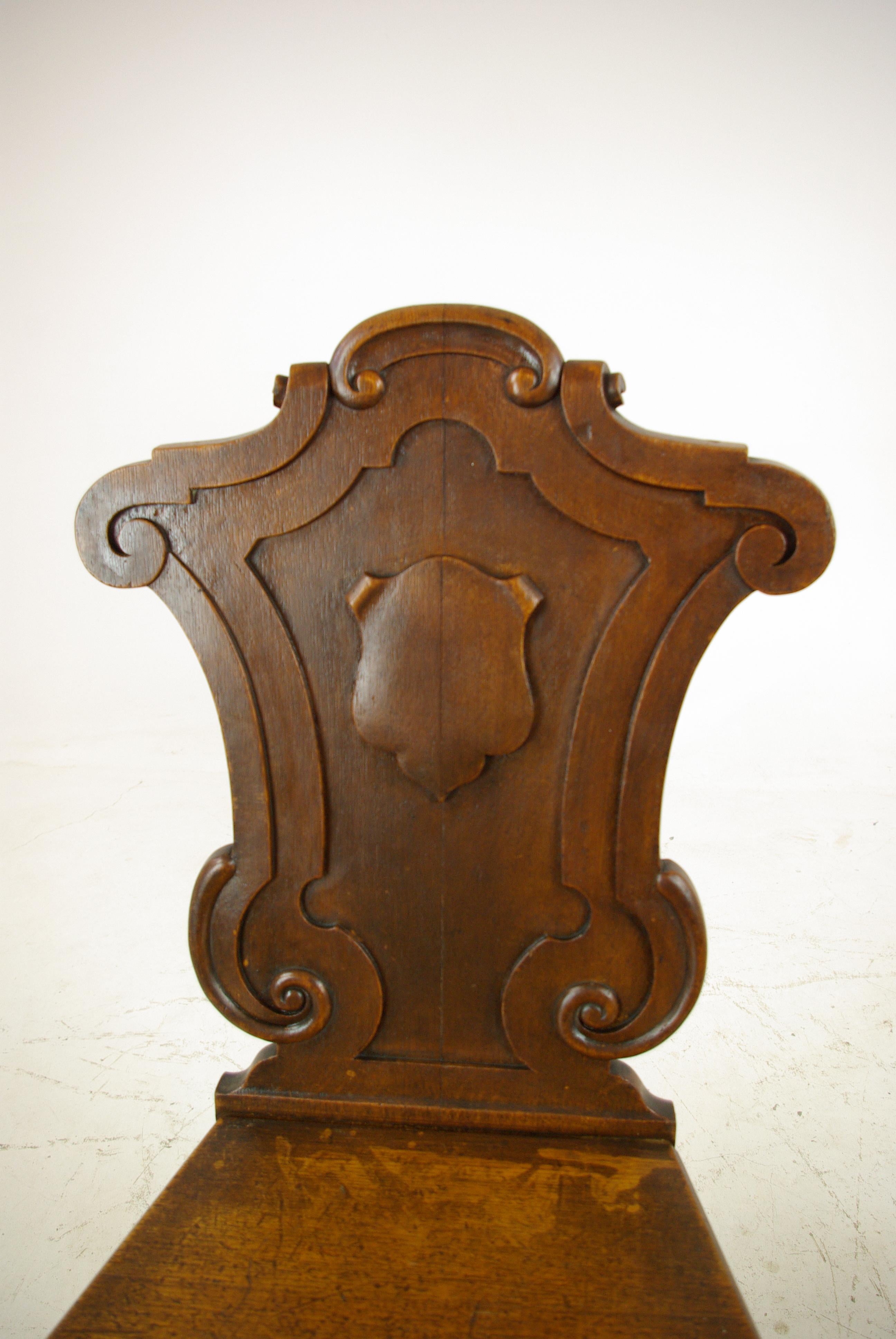Antique oak hall chairs, Regency hall chairs, Scotland, 1820, Antique Furniture, B1089.

Scotland, 1820.
Carved shaped backs
Central shield to back of chair
Solid shaped seats of tapering form
Raised on turned legs on front
Outswept sabre