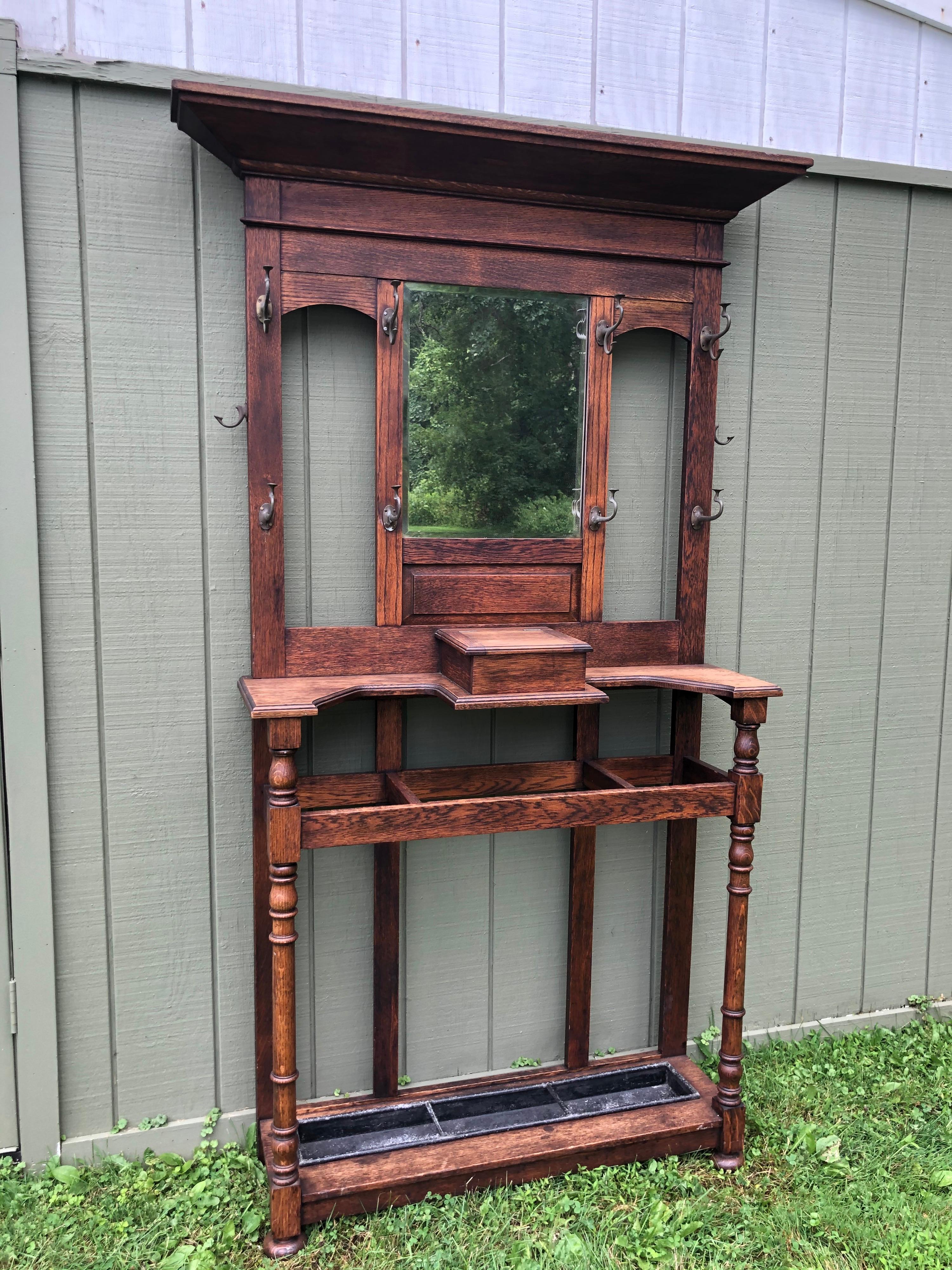 ON SALE-Antique oak hall tree with mirror. Excellent quality solid oak construction with original hooks. Perfect for a entry way or mudroom. Also would work in a walk in dressing room. You can move the side hooks or add extra hooks if needed along