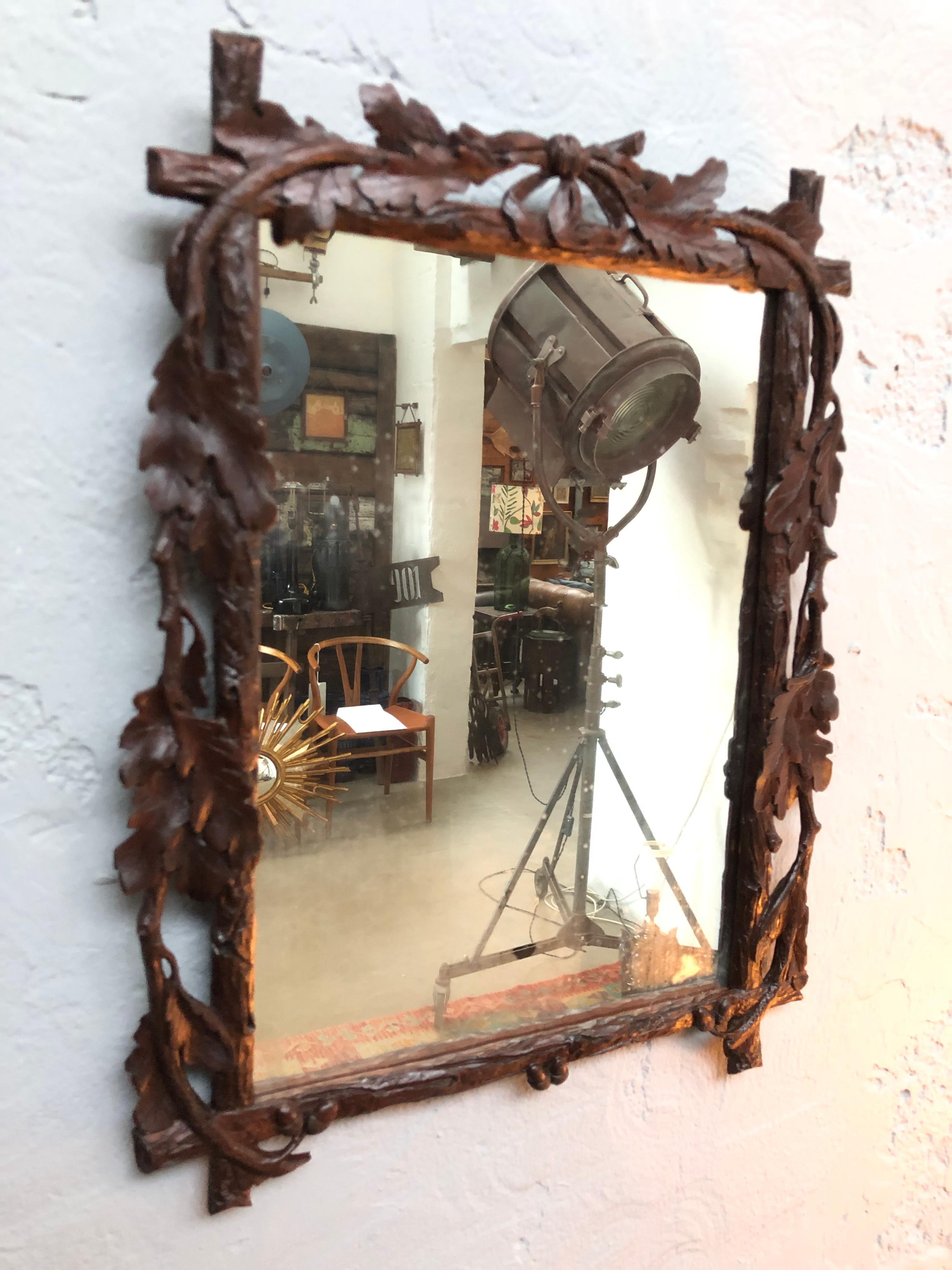 Antique wall mirror from the late 1800s.
This beautiful hand carved mirror is in original condition with the original glass plate and the original back plate. 
There is no active woodworm at all in the frame or backplate. 
With carved oak leaves and