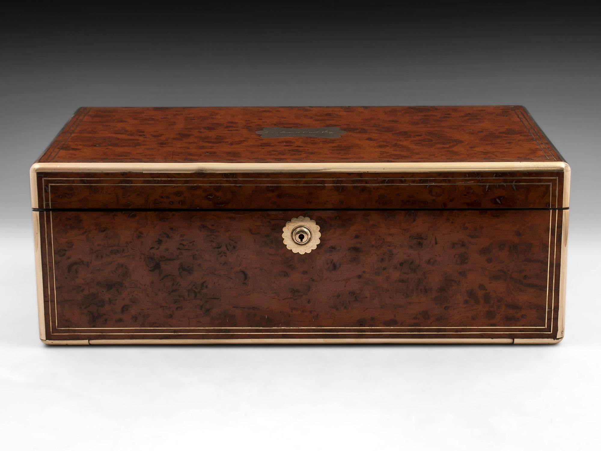 Antique brass bound writing box veneered in stunning pollard oak, with double strung brass, flush fitting campaign style handles and a large ornate initial plate engraved: John Ianson Croft Esq. In testimony of regard. This fabulous writing box is