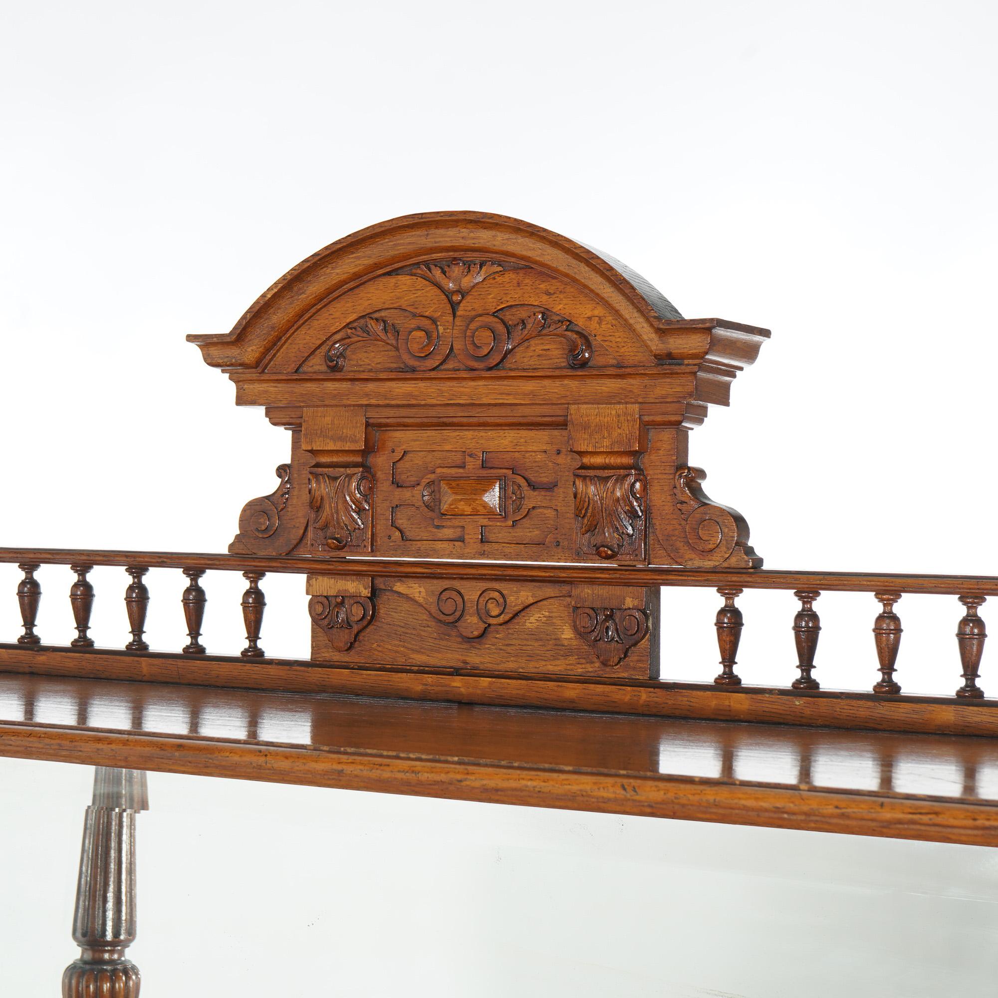 ***Ask About Reduced In-House Delivery Rates - Reliable Professional Service & Fully Insured***
Antique Oak Marble Top Server with Mirrored Back Splash, Carved Crest & Spindled Rail Raised on Turned Columns with Lower Shelf and Bun Feet, Original