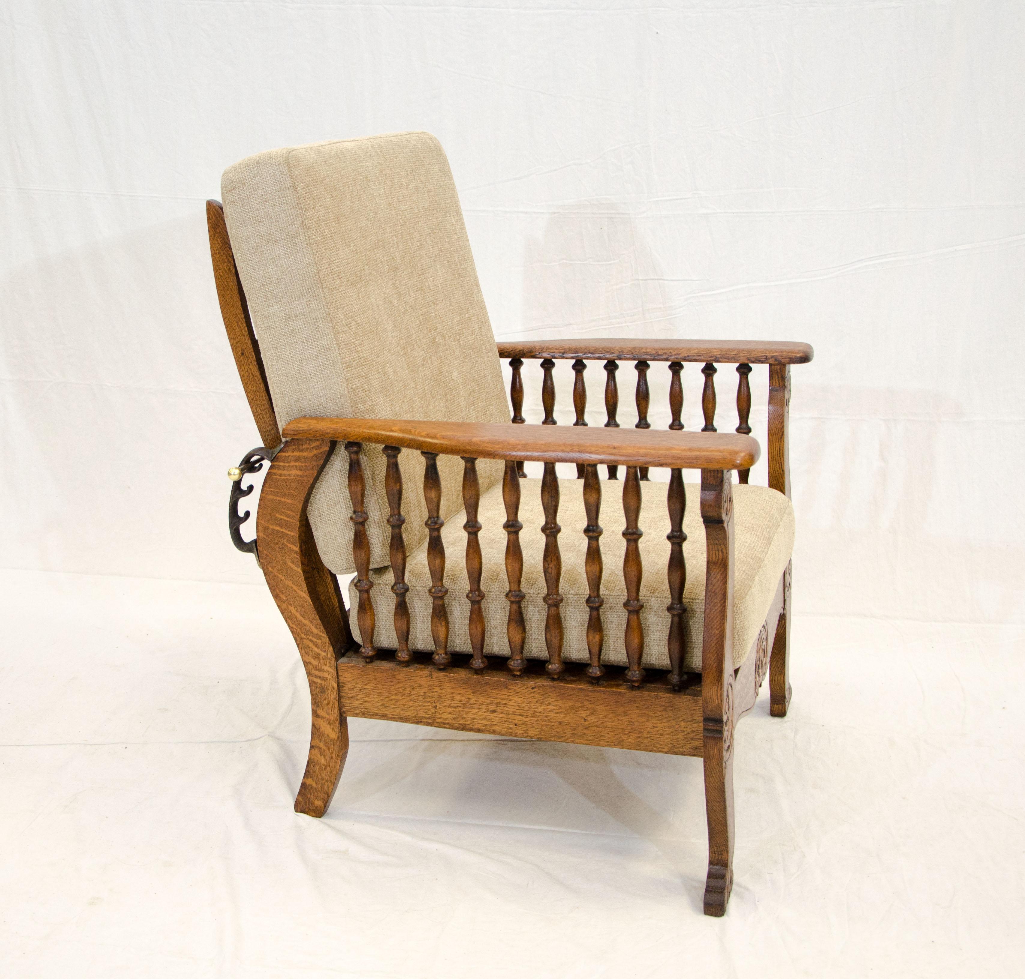 Nice antique quarter-sawn oak Morris chair with press carved front frame and turned spindles. The newly upholstered 4