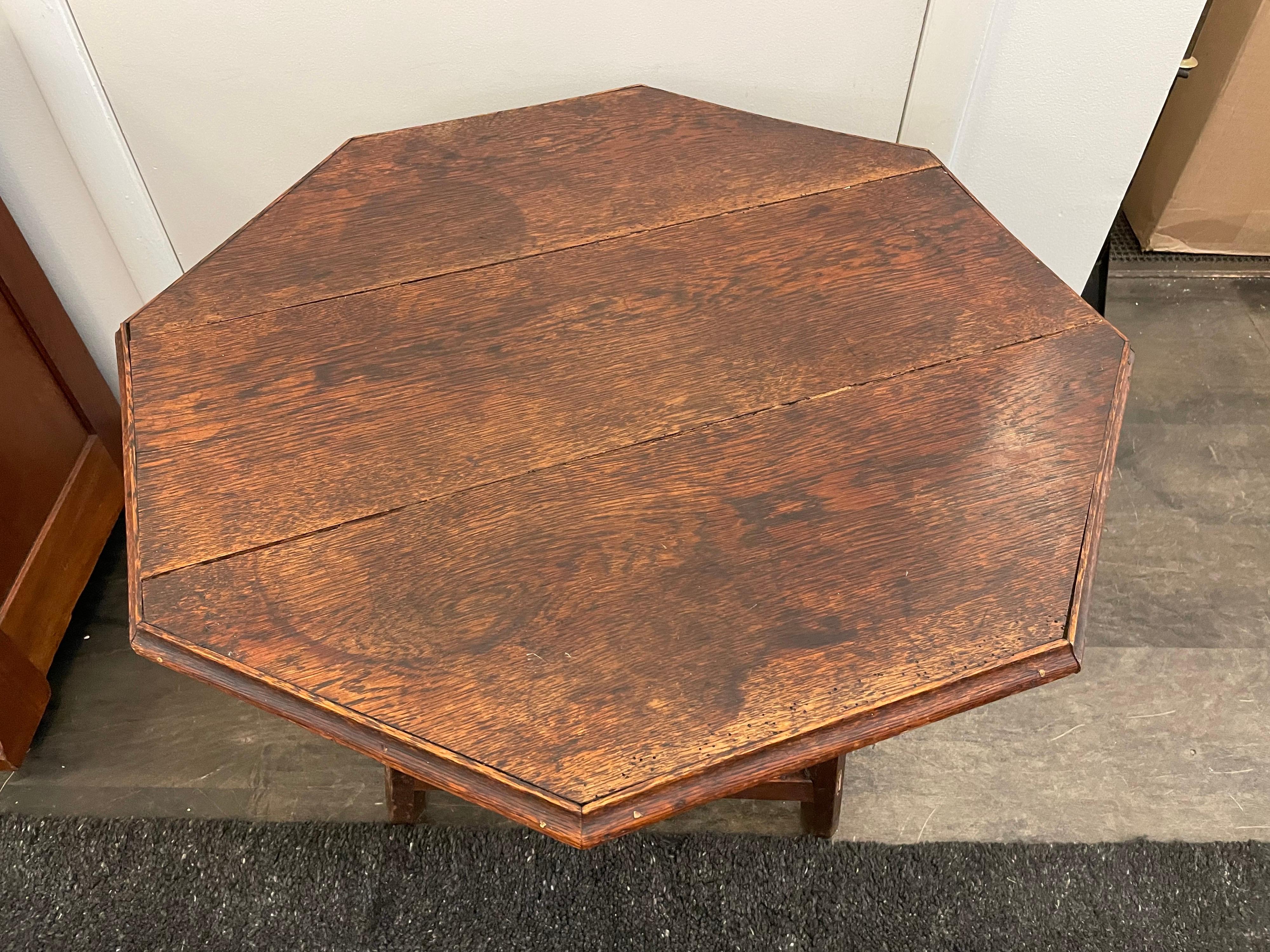 Hexagonal top detail to this wonderful aged oak occasional / side table. Wonderful coloring / patina from age and use. Triangular flared base.