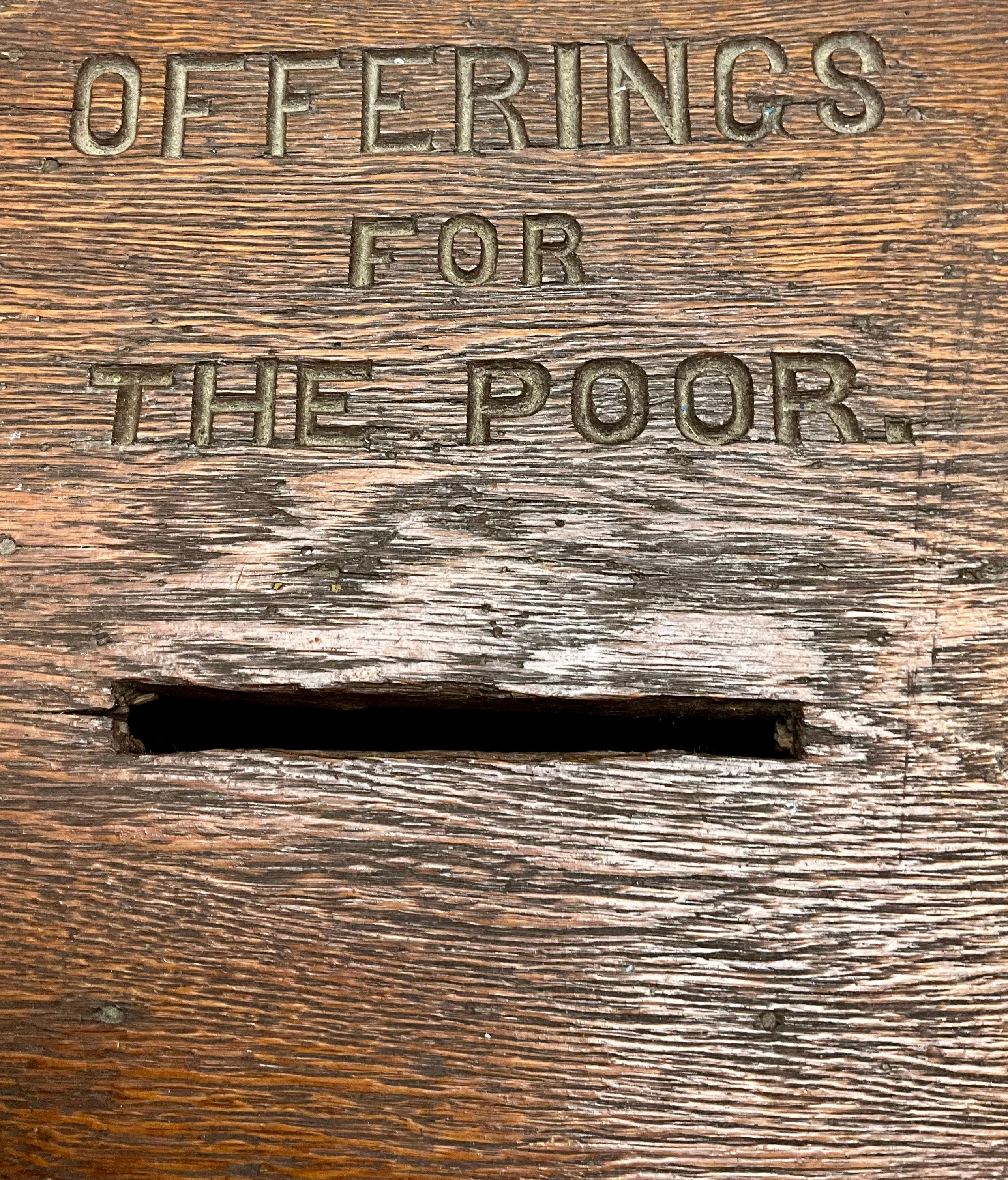 Antique Oak Offering Box for the Poor
This charming late 19th century antique offering box, crafted from rich oak, features a beautifully engraved inscription reading 