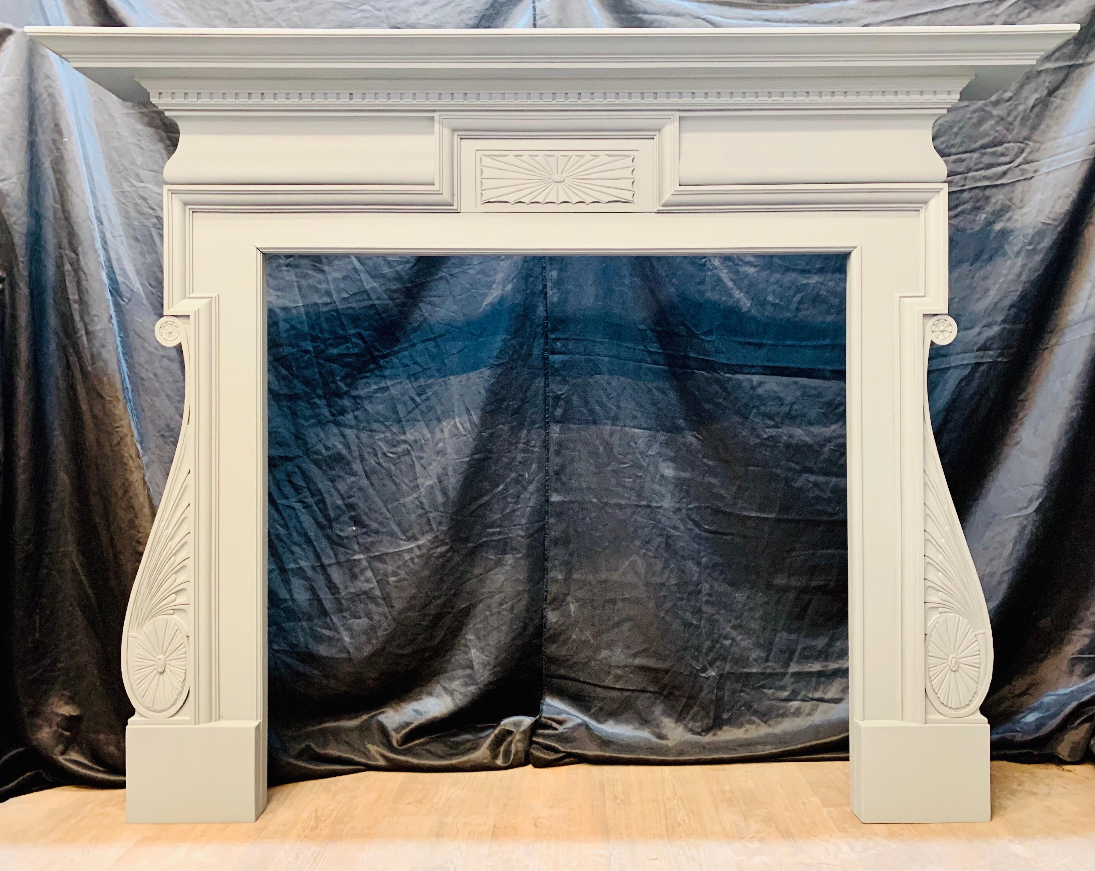 A large late Victorian painted Oak fireplace surround in the Palladian manner. A substantial moulded top shelf  with a cornice of dental check sits above a frieze with a central rectangular carved patera flanked by bolection moulding that returns