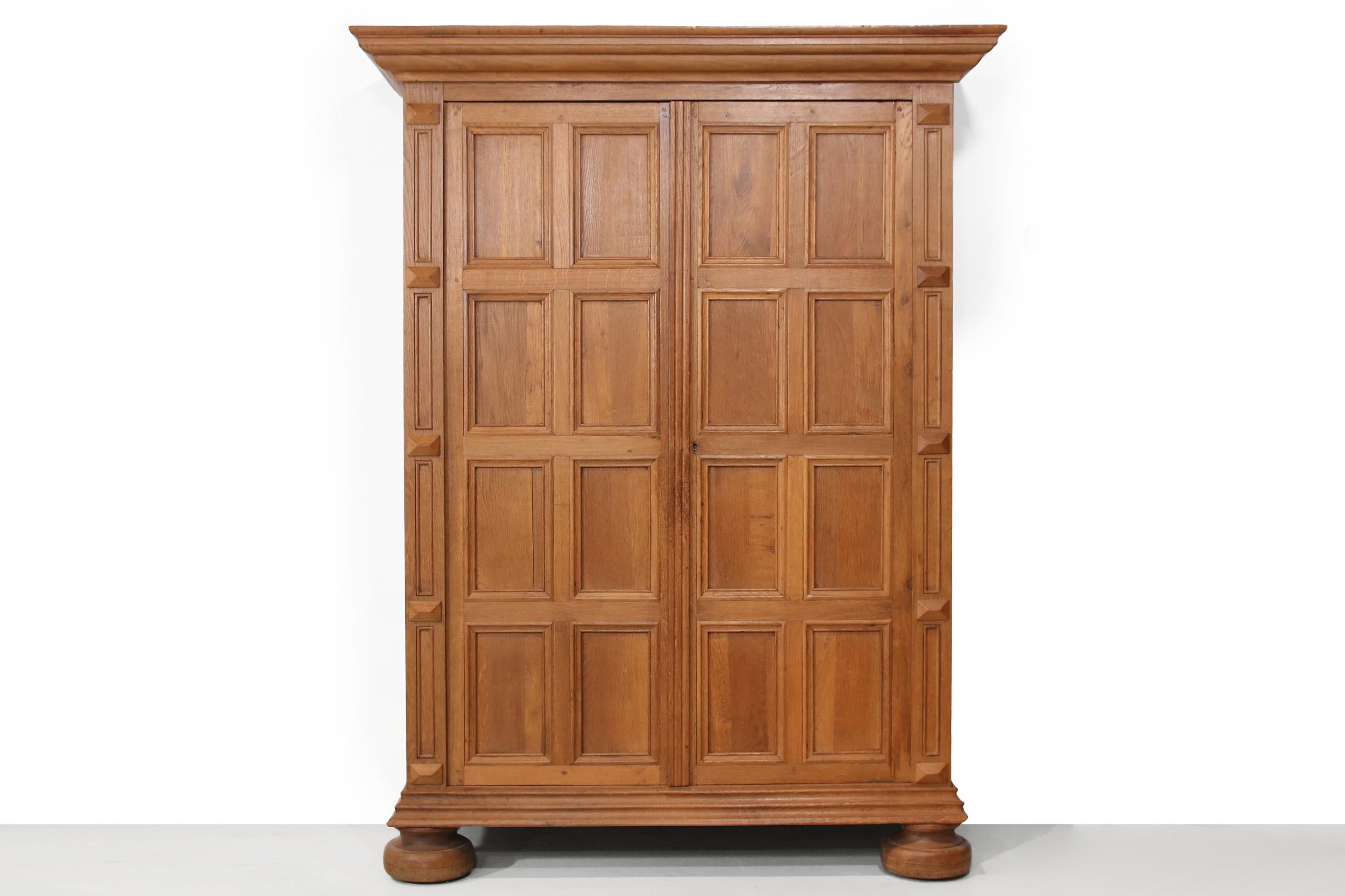 Elegant, monumental solid oak cabinet from the 19th century. Beautifully detailed and incredibly solid, crafted by a cabinetmaker. The doors feature a beautiful pattern of recessed panels, framed by subtly profiled stiles and rails. The cabinet