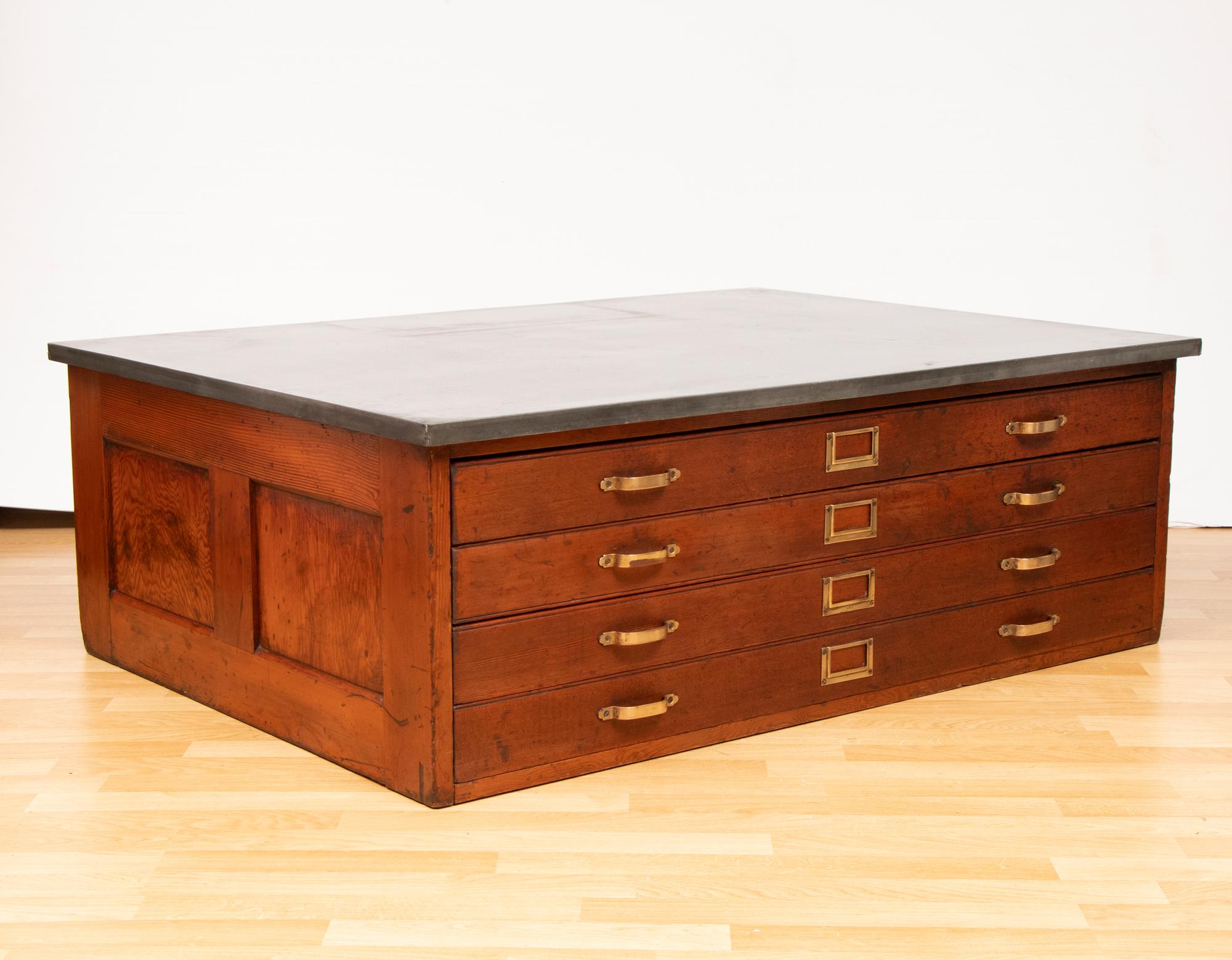 A very handsome antique oak plan or map chest which has been converted into a low coffee table with a zinc top added later. The chest comes with four detachable wooden casters which can be added depending on your requirements

The four deep