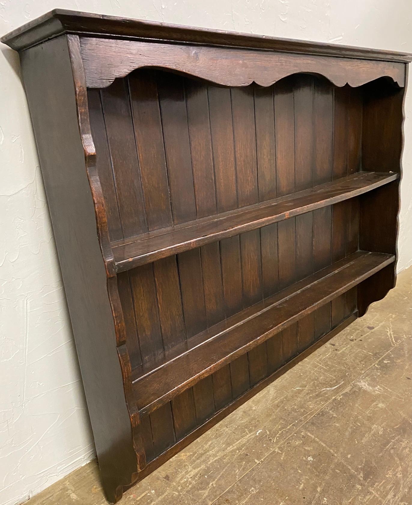 Antique dresser plate or dish rack made from oak with crown molding at the top over a hand scalloped cornice. The rack has 3 shelves. It once sat on top of a buffet which is no longer available. It can sit on top of another cabinet, sideboard or be