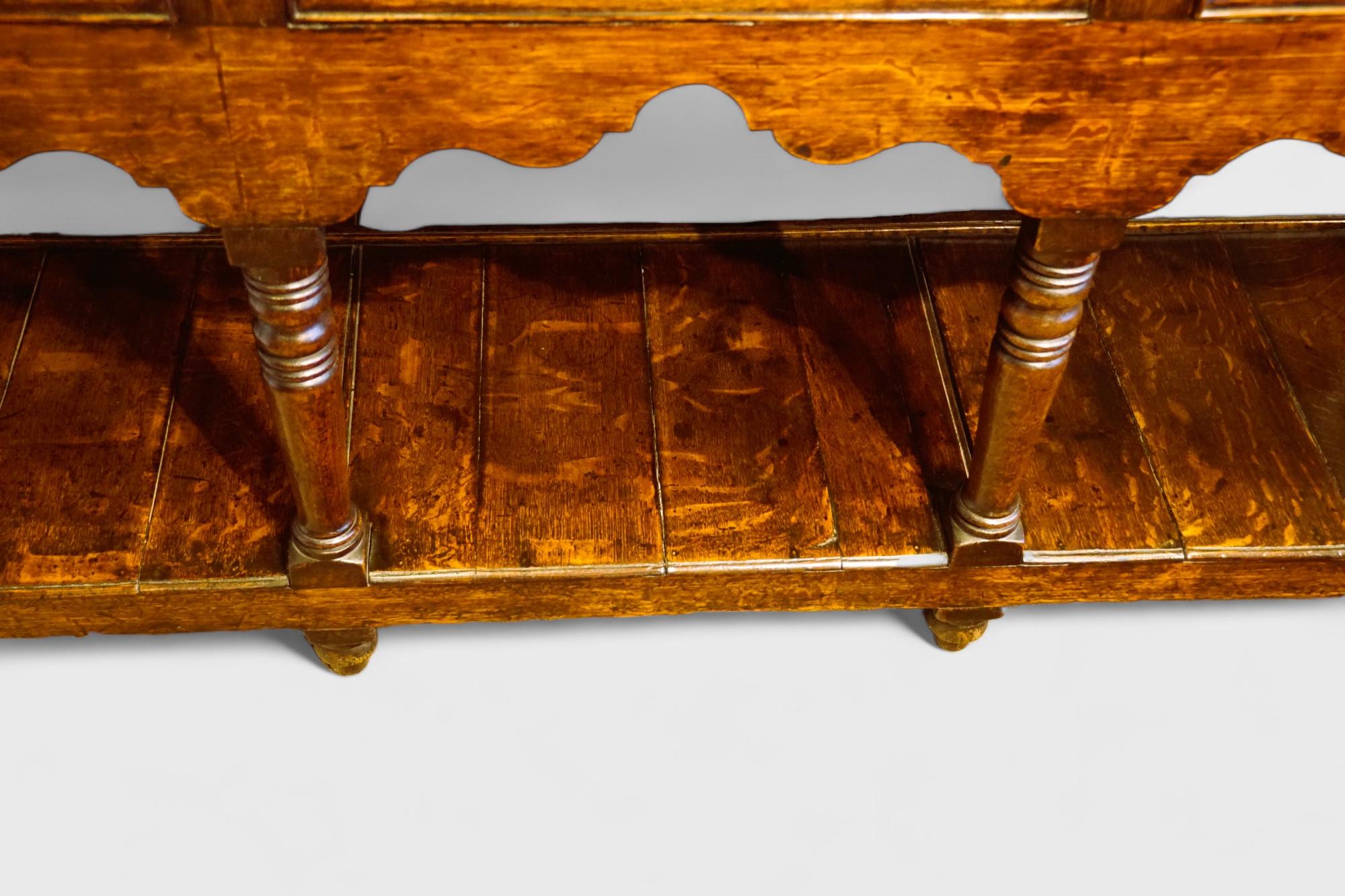 Antique oak pot board dresser 
This Antique oak pot board dresser was made circa 1810.
It is fitted 3 drawers with swing handles and fretted brass back plates, that are above the attractive shaped apron.
There are 3 well turned legs to the front