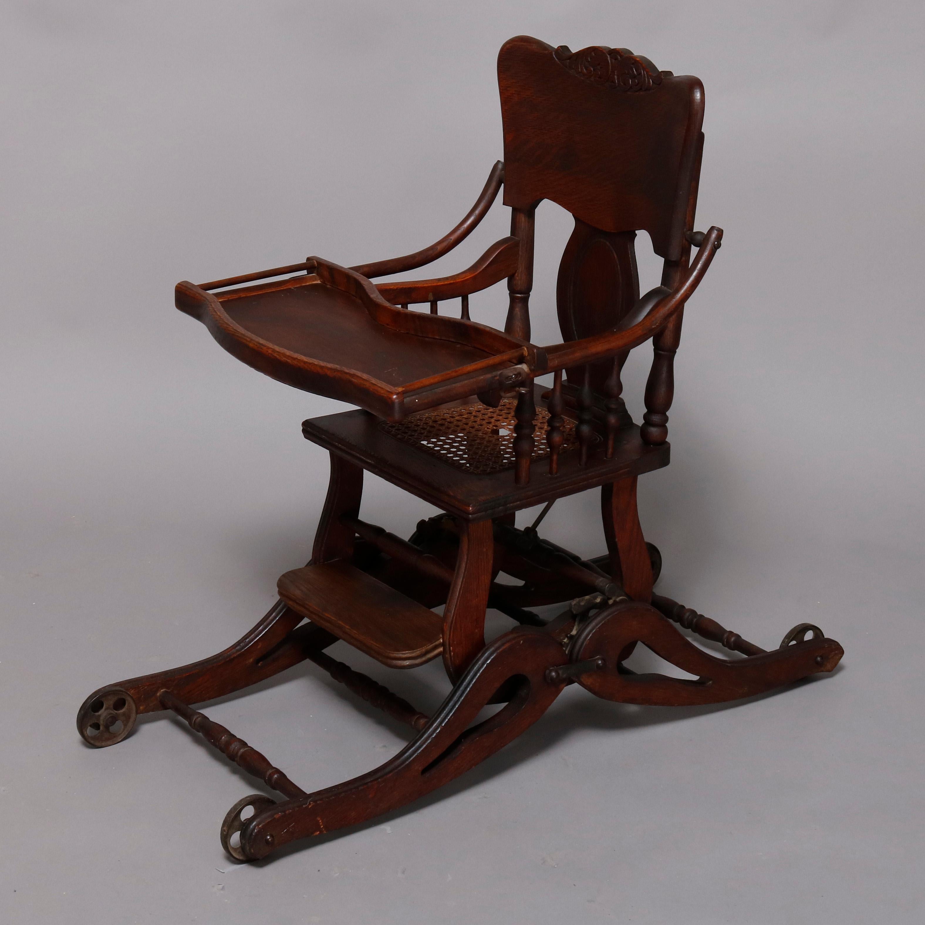 An antique child's highchair offers oak construction with pressed scroll decorated slat back surmounting caned seat and shaped tray, converts from rocker to highchair, circa 1910

Measures: 40.5
