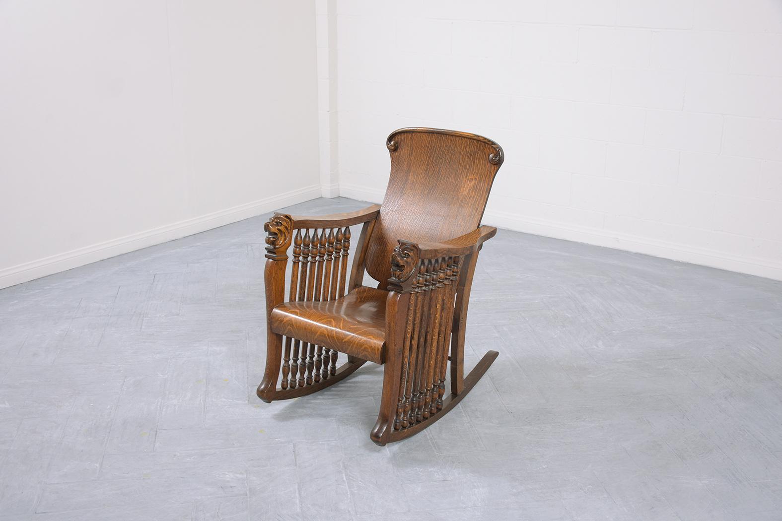 This extraordinary American Empire-style antique oak rocking chair is in great condition beautifully crafted out of oak and has been newly restored by our expert craftsmen team. This antique chair is eye-catching and features intricately hand-carved