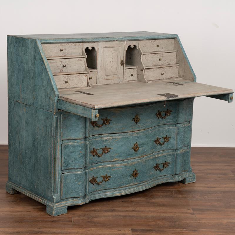 This oak rococo secretary reflects the grace and class of Swedish styling in the early 1800's. The dramatic serpentine drawers with curvaceous front add a romantic touch, all resting on solid block feet. The traditional interior with 8 unique, small