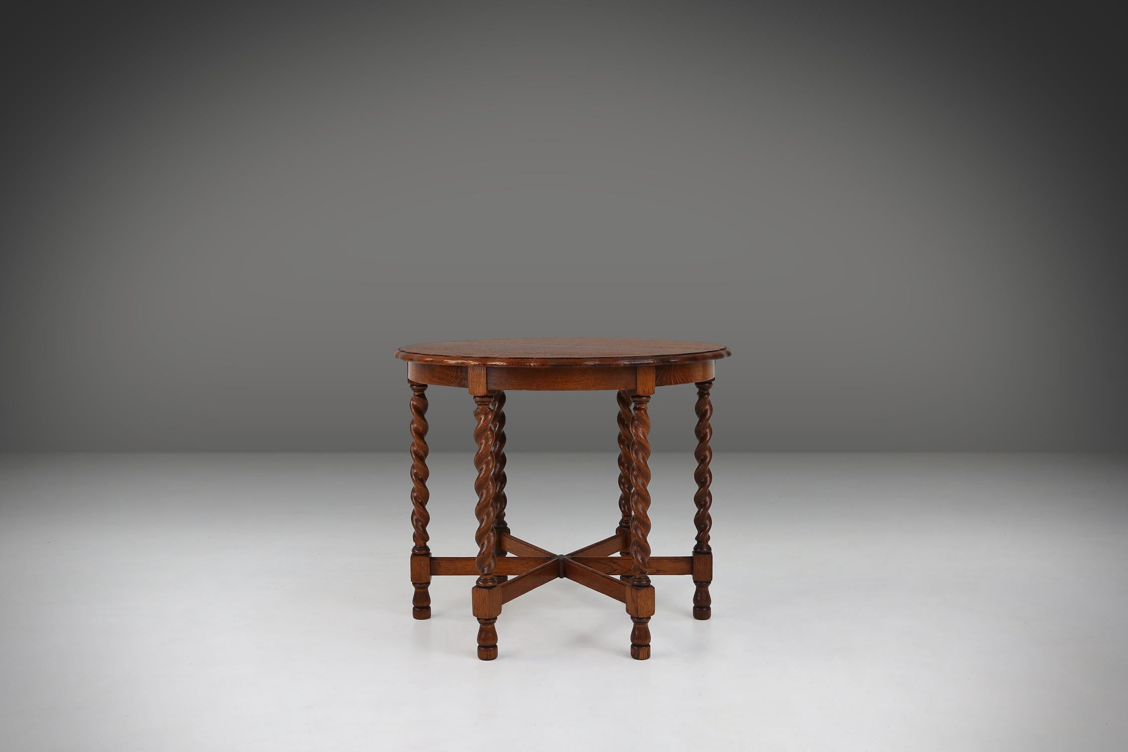 Made from oak around circa 1890, this side table has a beautiful wavy top that gives an elegant look. The six turned legs are a model of craftsmanship and refinement. The wood has a rich, dark hue that is testament to its age and quality.

This side