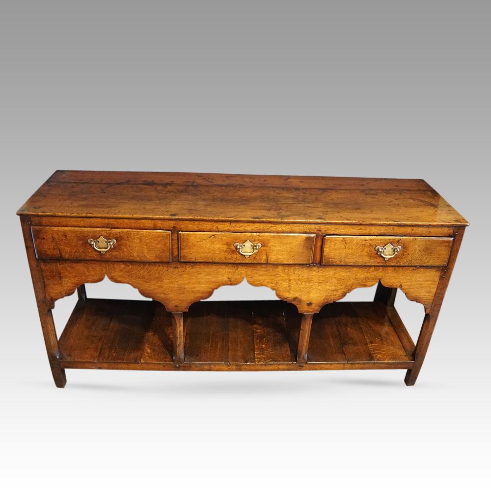 Antique South Wales oak dresser base
This Antique South Wales oak dresser base was made in the Georgian period circa 1810.
It is of a lovely mid-honey colour with a lovely patina.
The Georgian dresser is fitted 3 drawers with brass handles that are