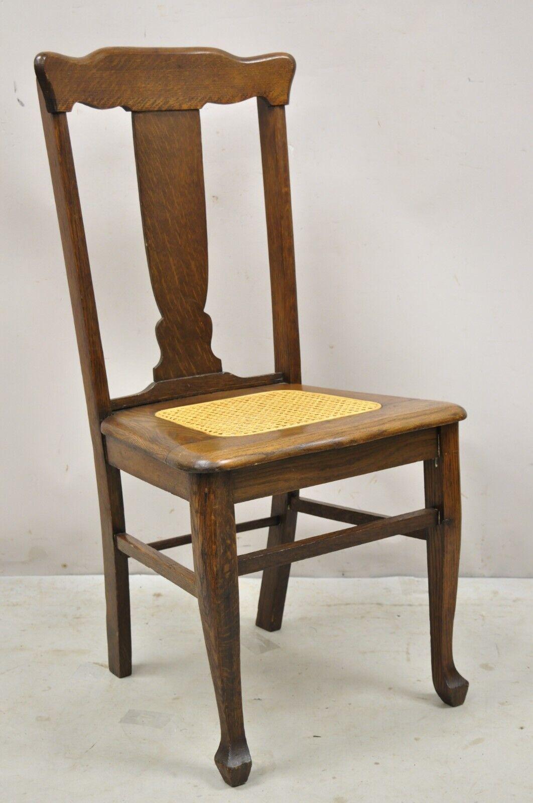 Antique oak T back dining side chairs with cane seat - set of 4. Item features Cane seat, T back backsplat, solid wood frames, beautiful wood grain, very nice vintage set. Circa early 1900s. Measurements: 39