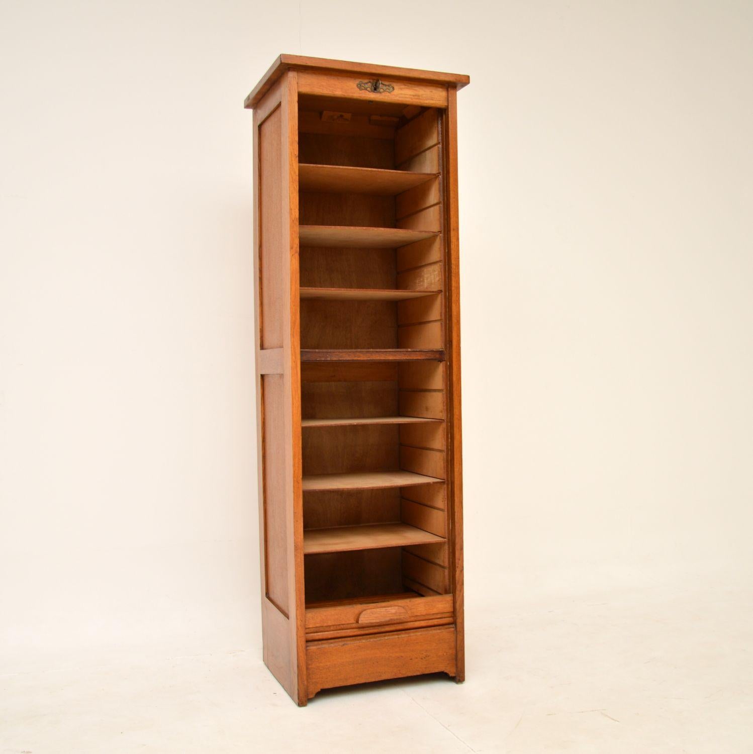 A charming antique filing cabinet in oak, with a roll down tambour door. This was made in England, it dates from around the 1930’s.

It is a very useful size, with very useful proportions and is of super quality. The tambour door unlocks and rolls